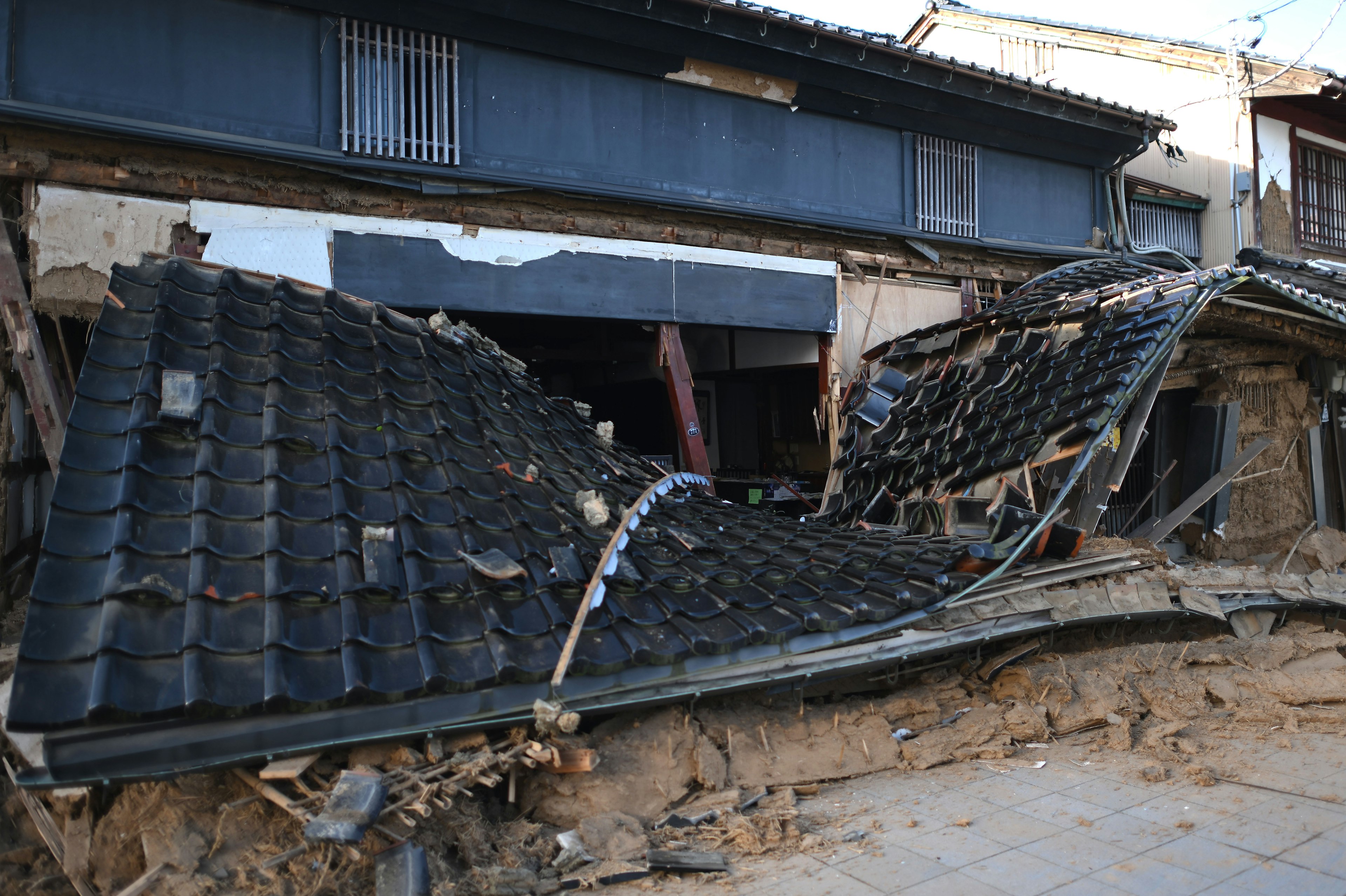 Collapsed traditional Japanese house roof due to earthquake damage