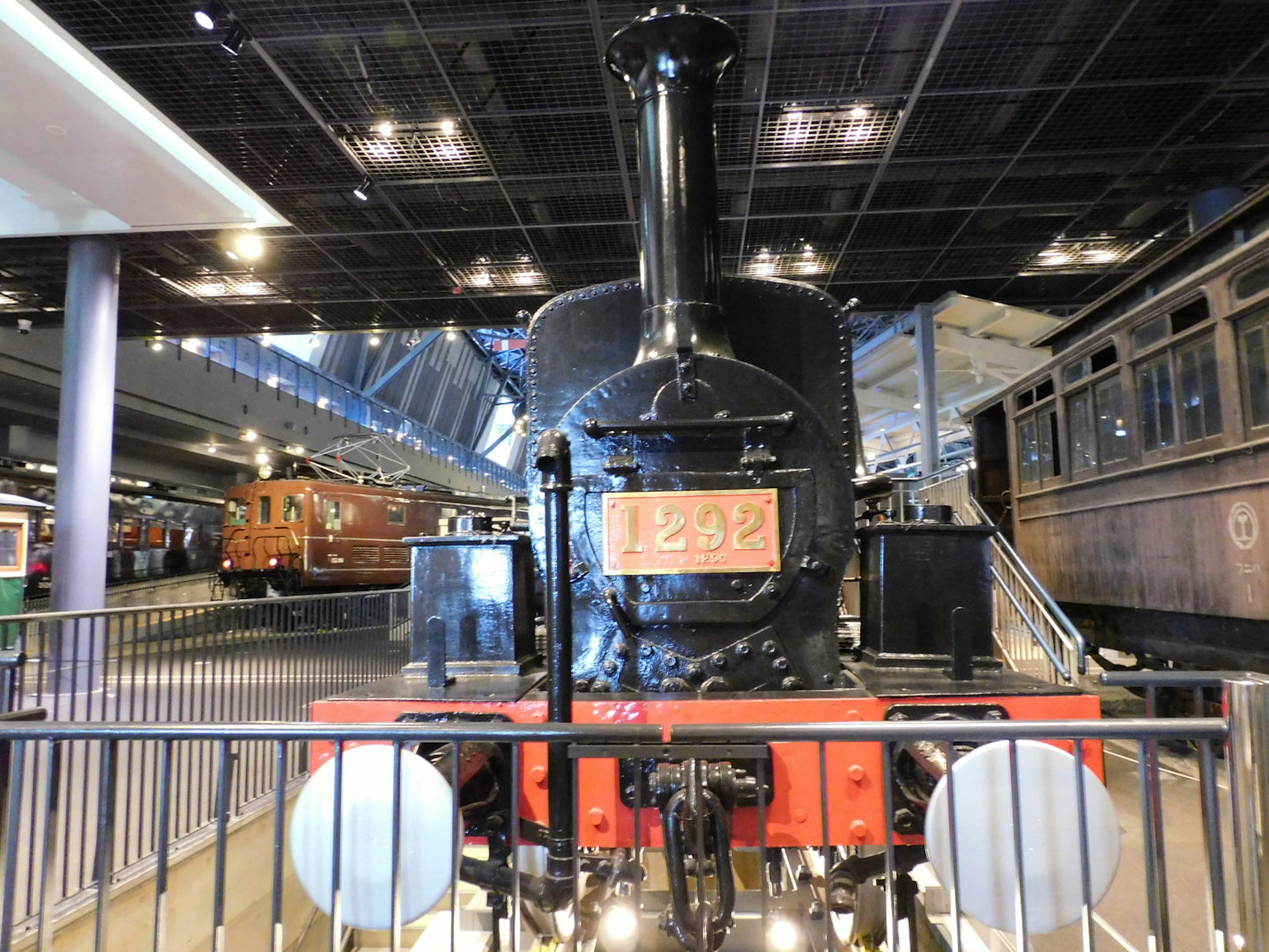 Black steam locomotive displayed in a museum interior