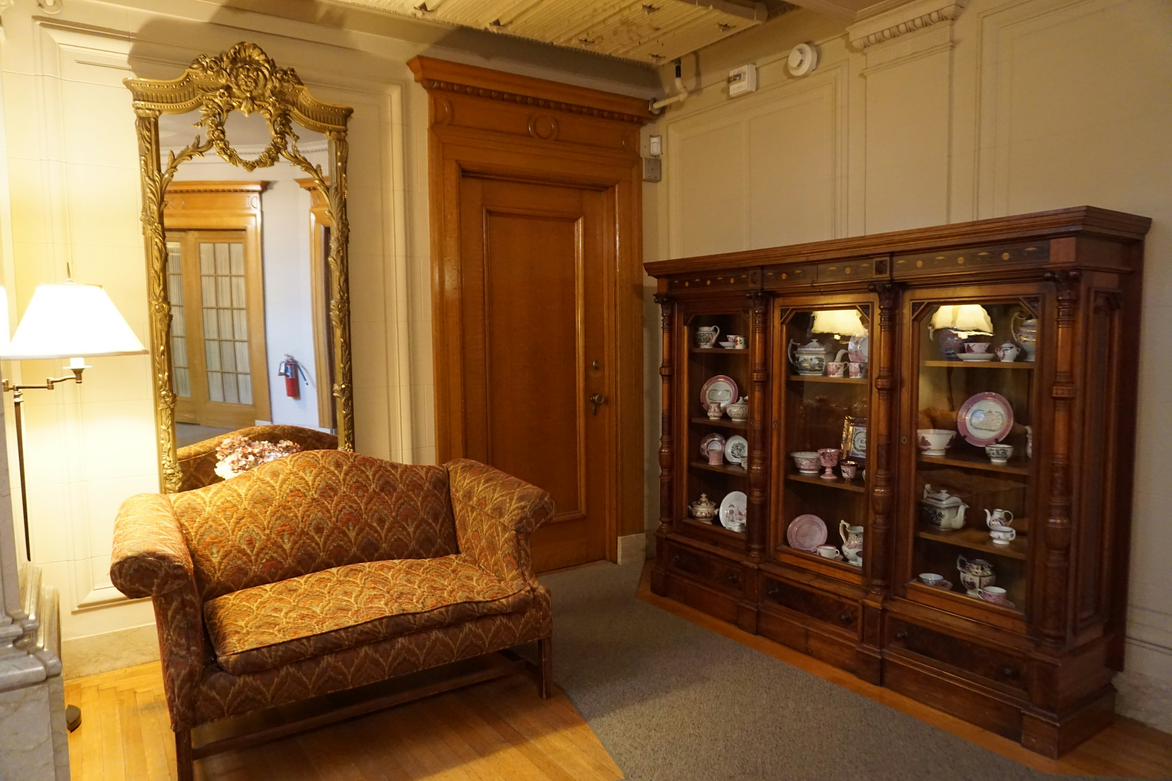 Elegant room interior featuring a luxurious sofa and decorative mirror