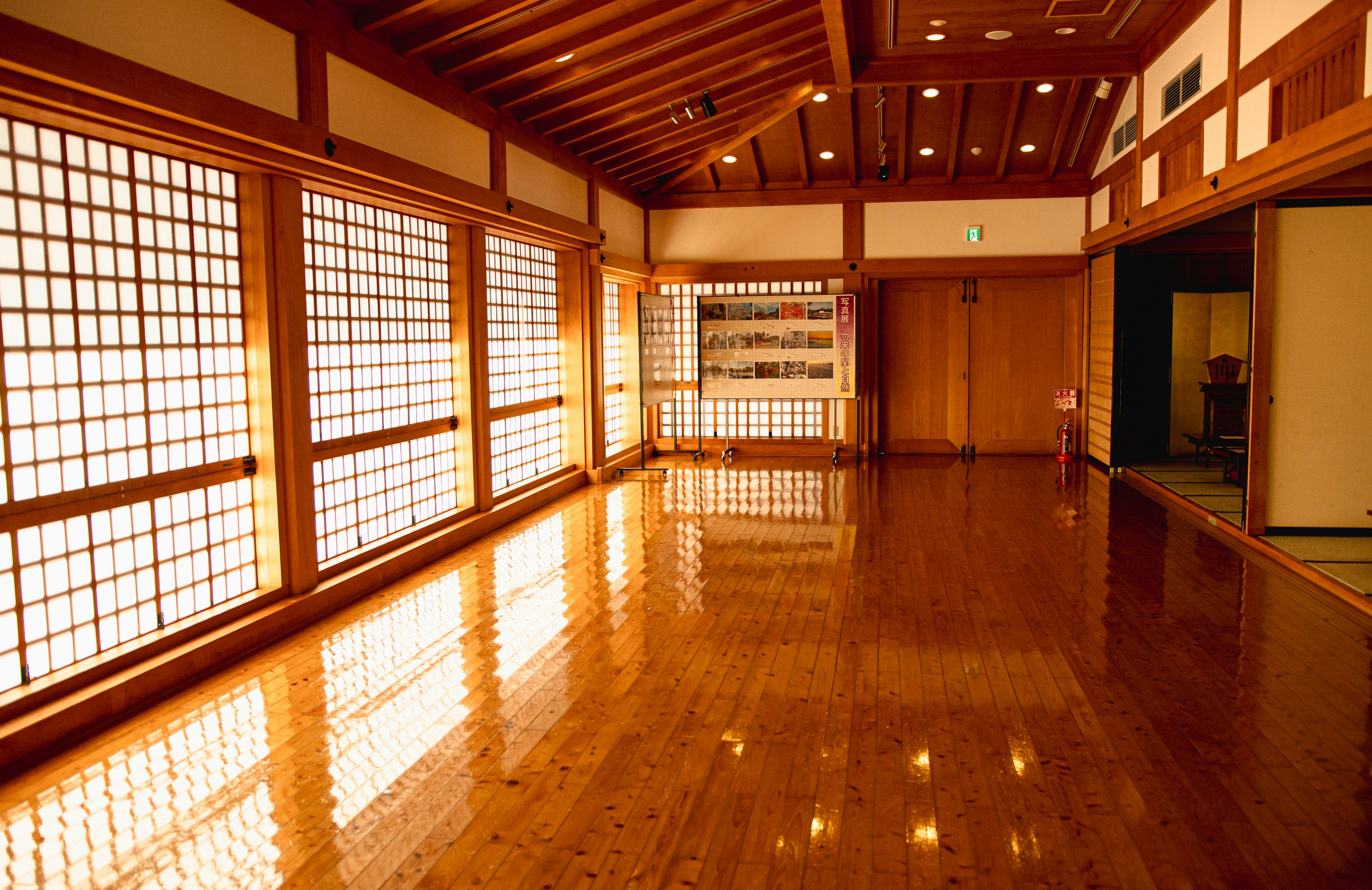 Interior of a spacious room with wooden flooring and traditional windows