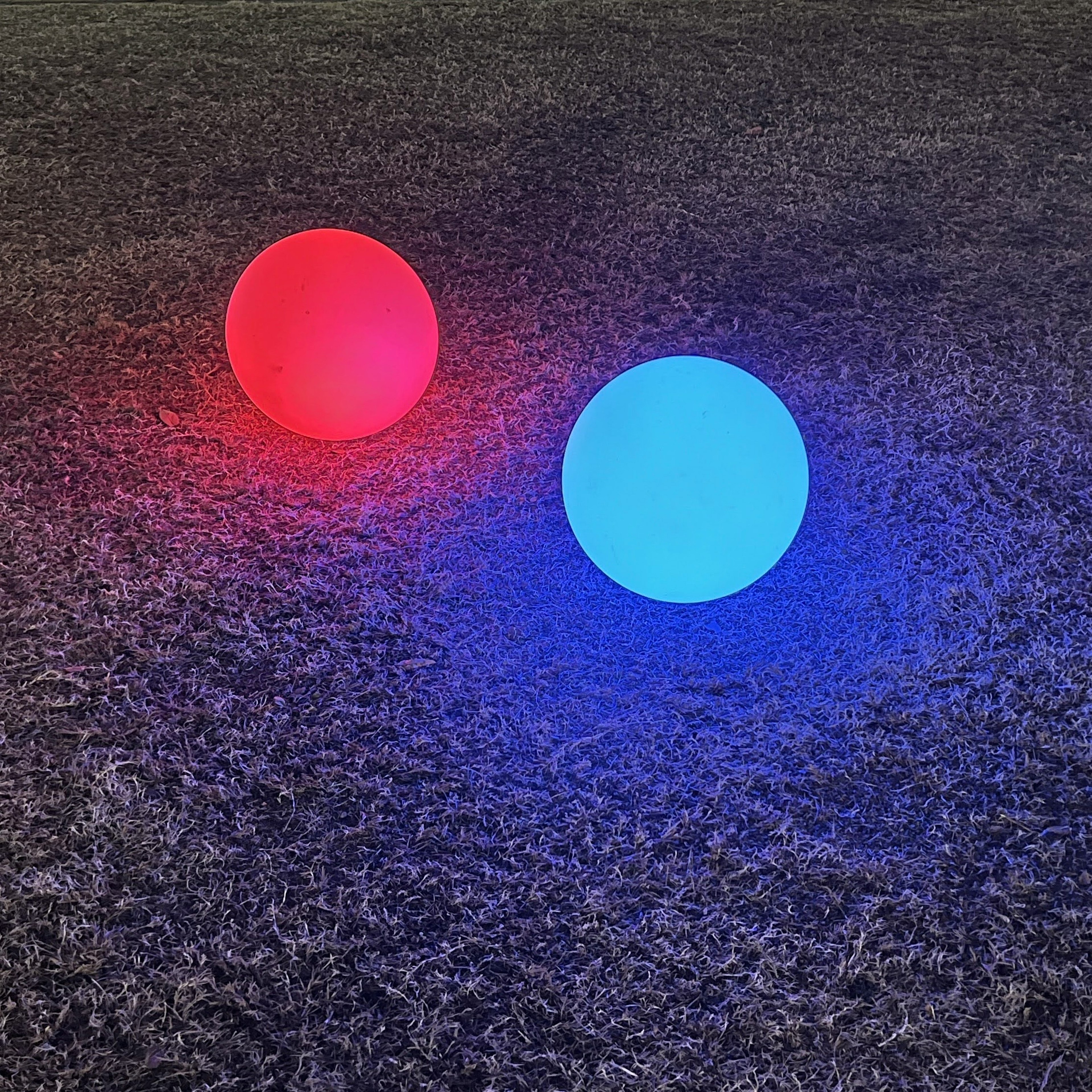 Red and blue glowing spheres placed on the ground