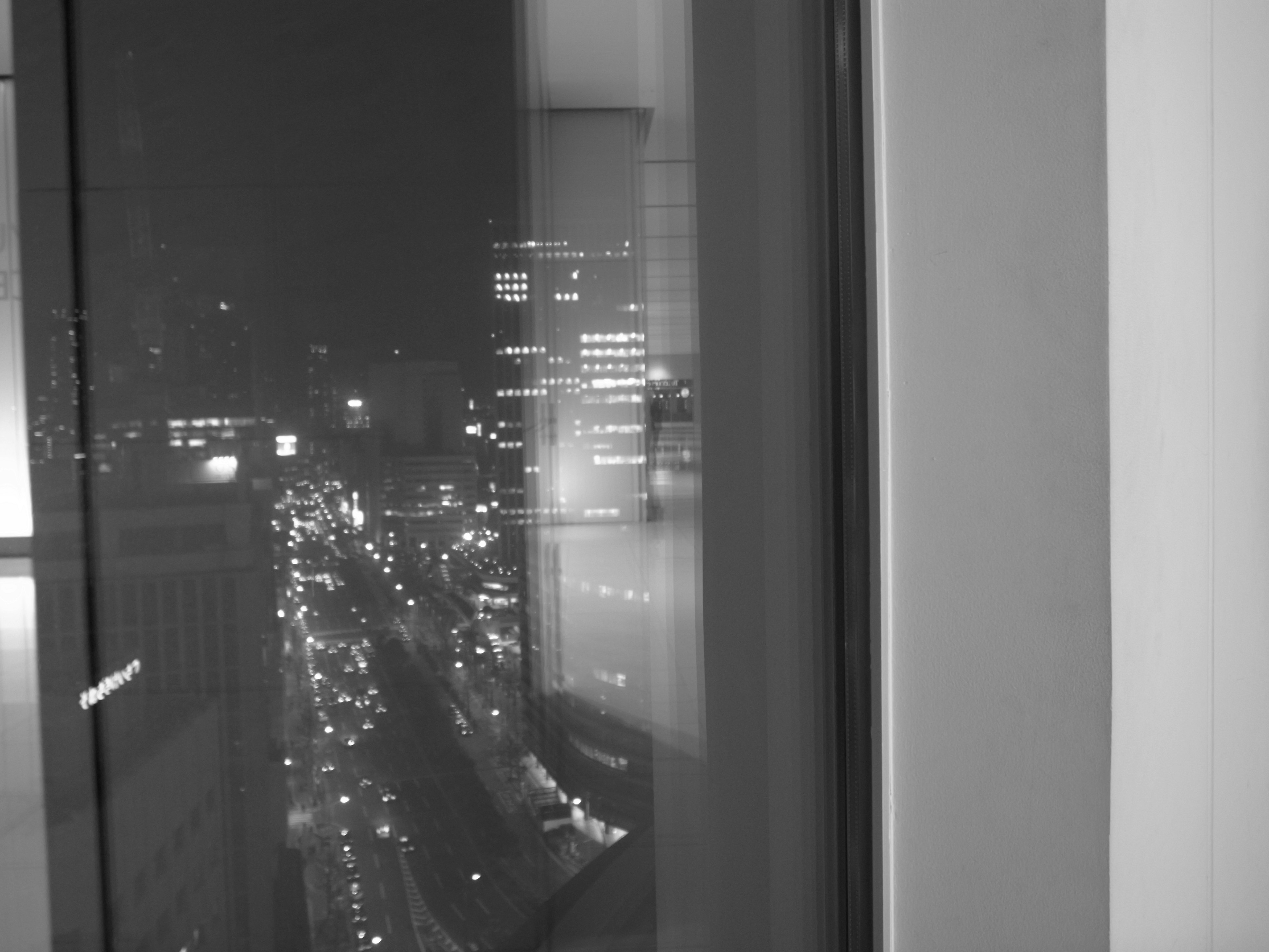 Night view of city buildings and street lights from a window