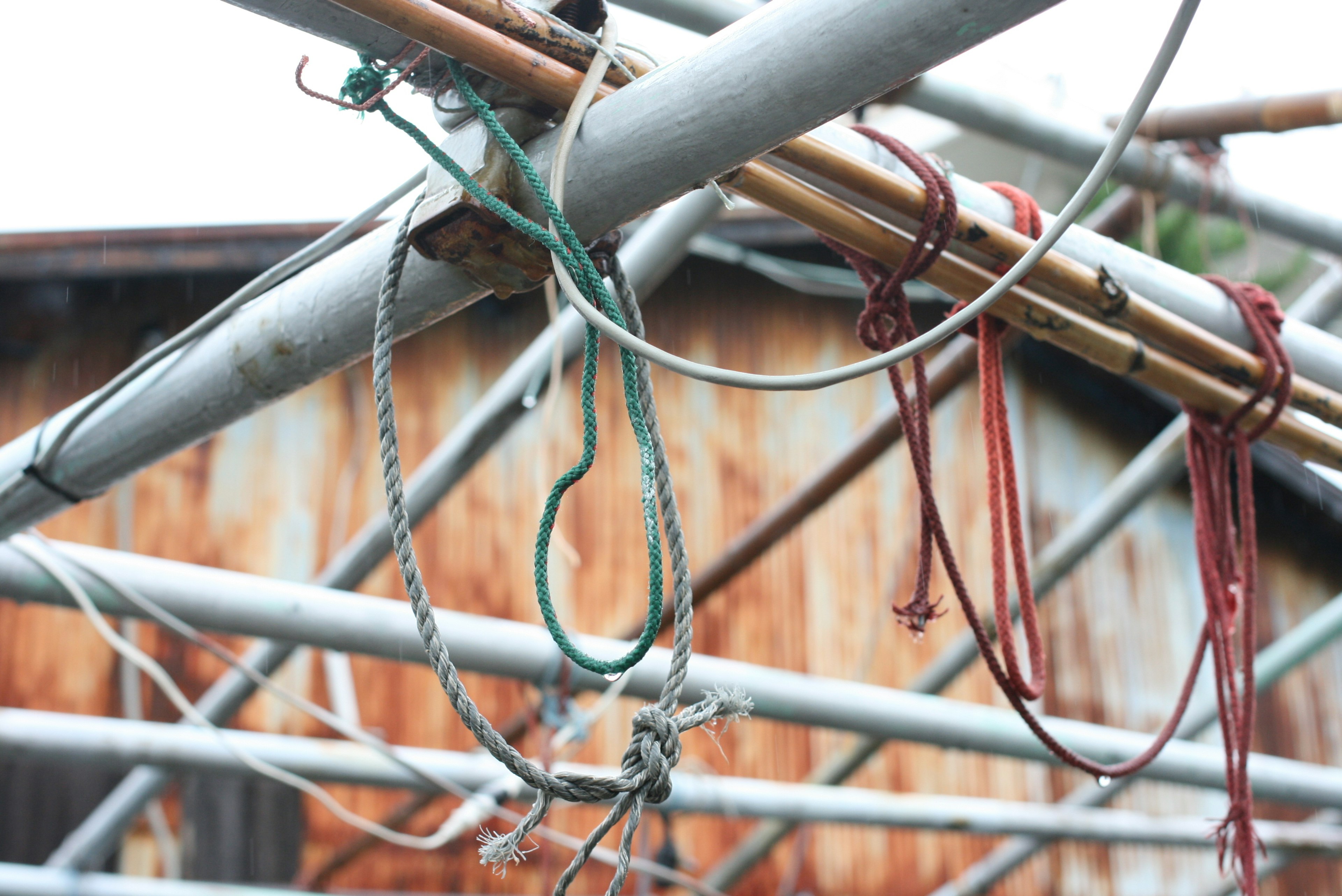 Close-up of ropes and wires tangled on a metal scaffold