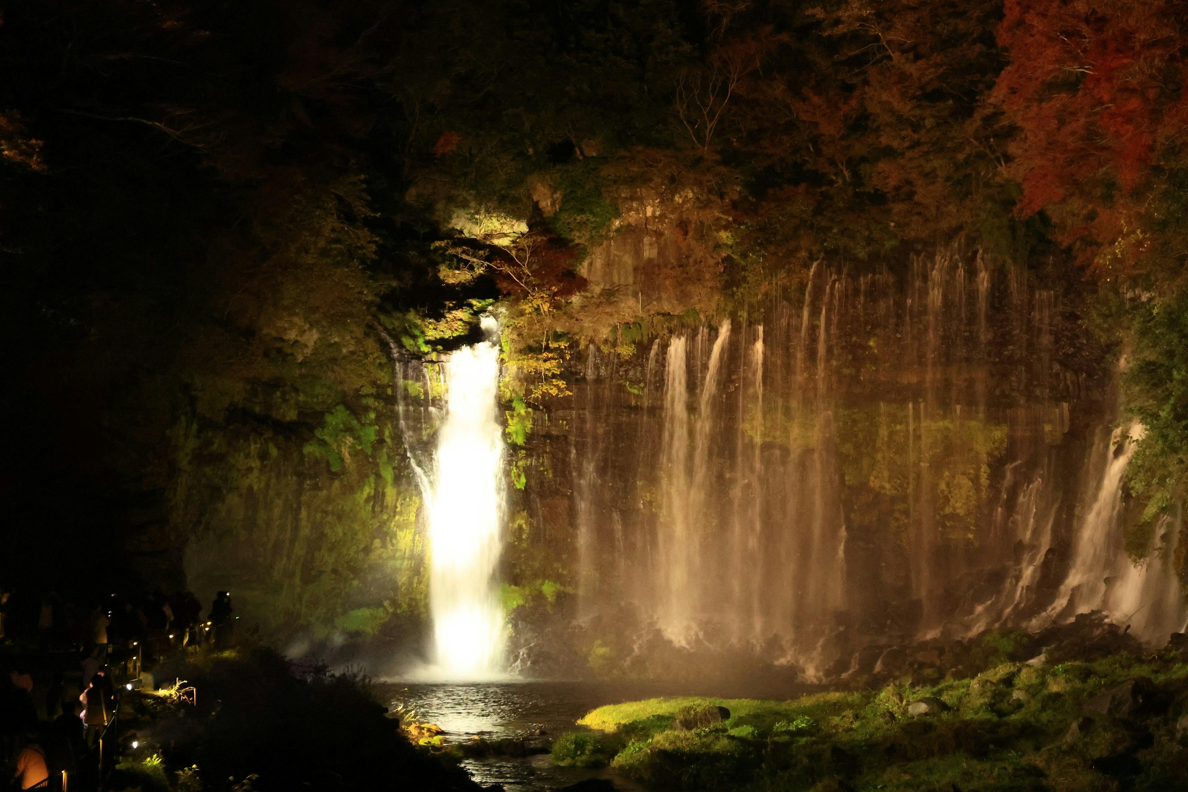 Beautiful night view of a waterfall with surrounding greenery