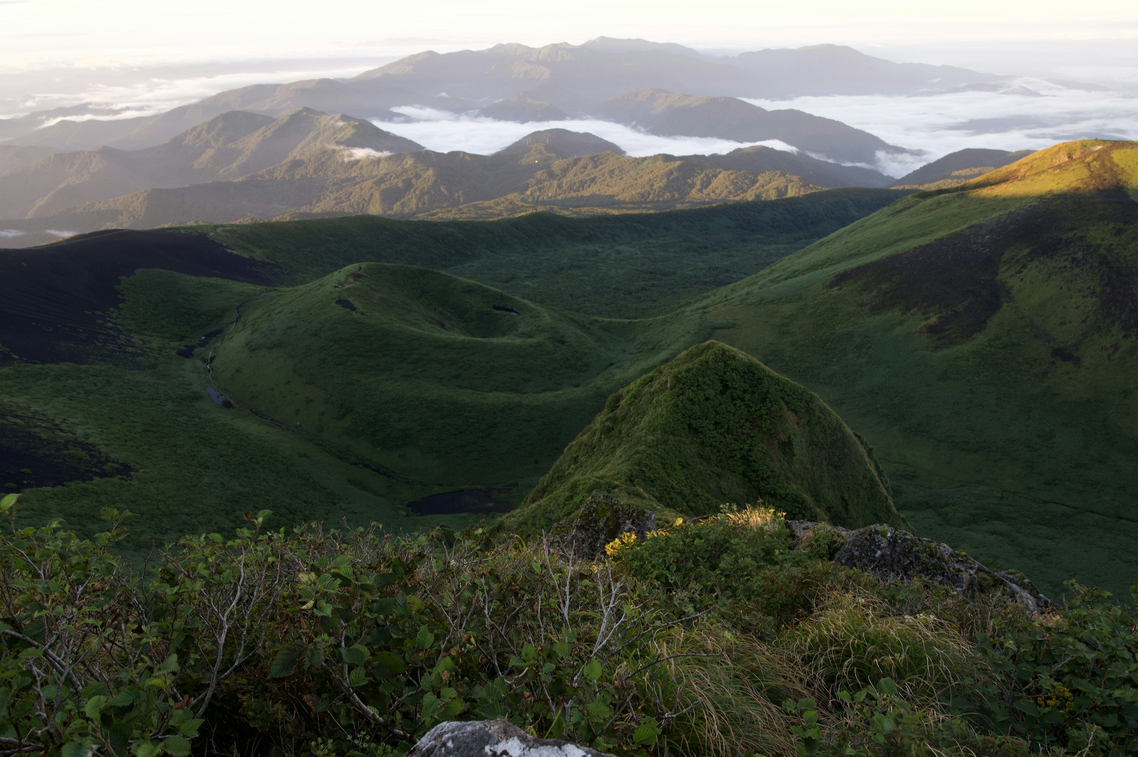 Lush green mountains and mist-covered valleys in a scenic landscape