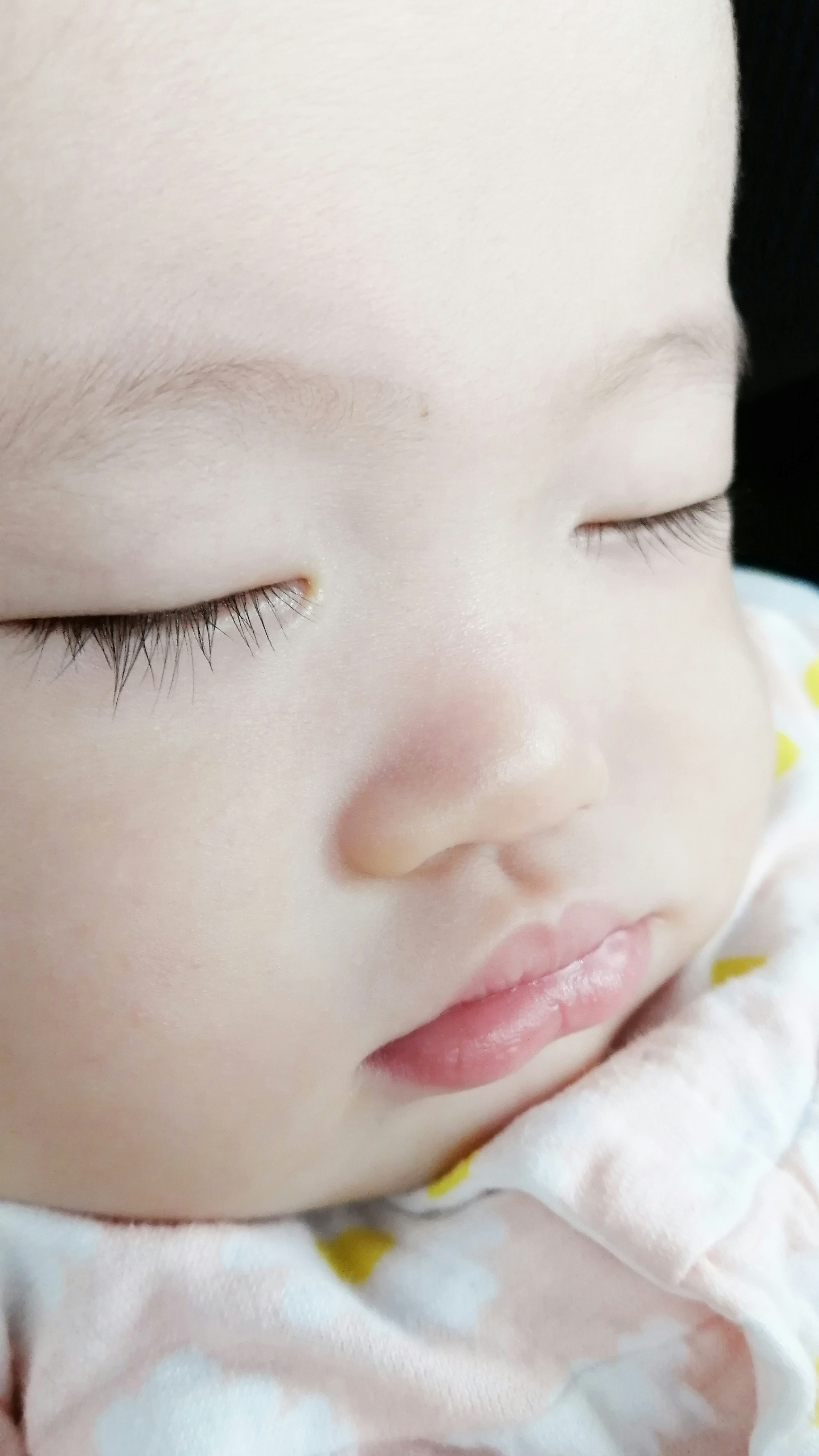 A baby sleeping with a serene expression