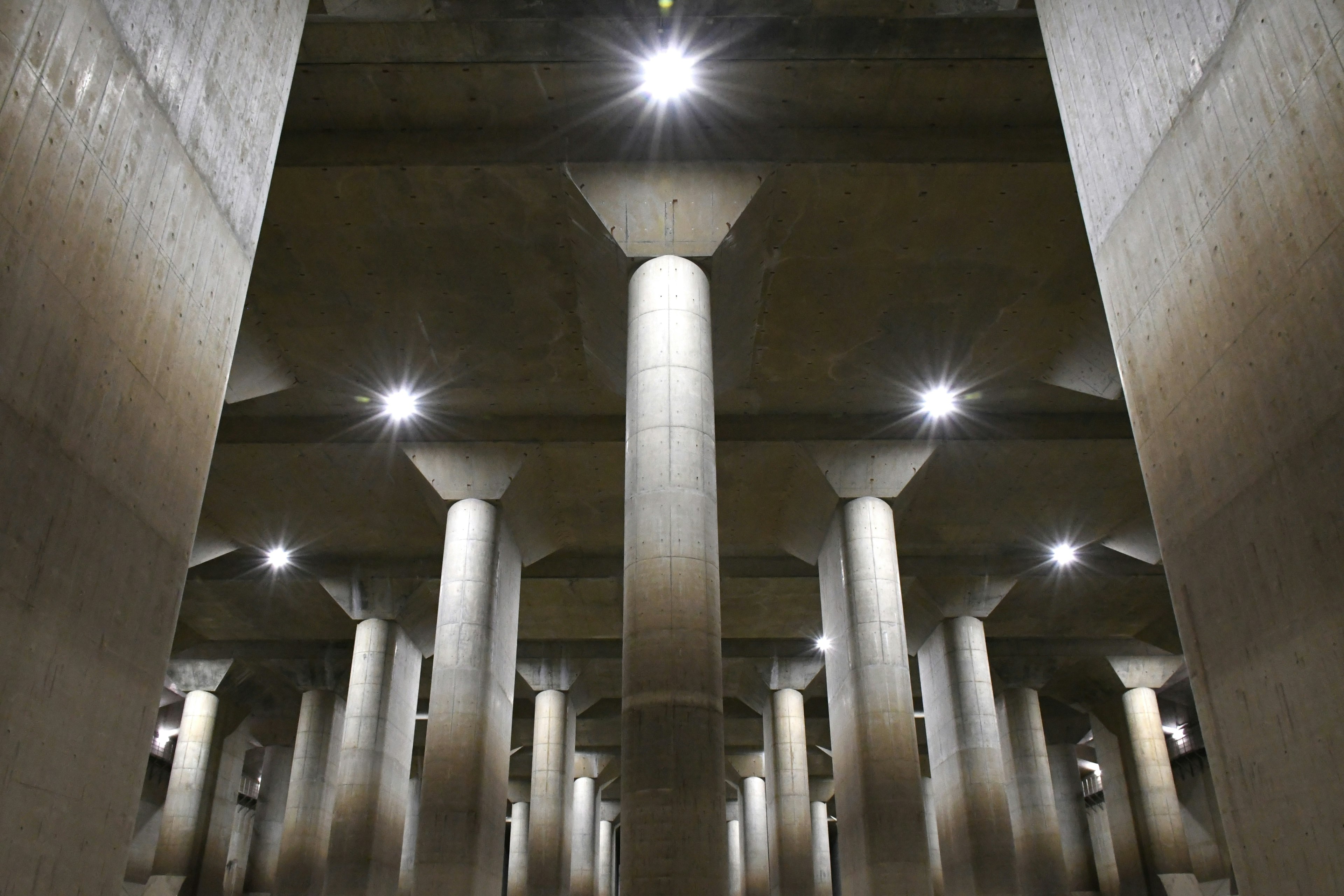 Interior view of a subterranean space with concrete pillars