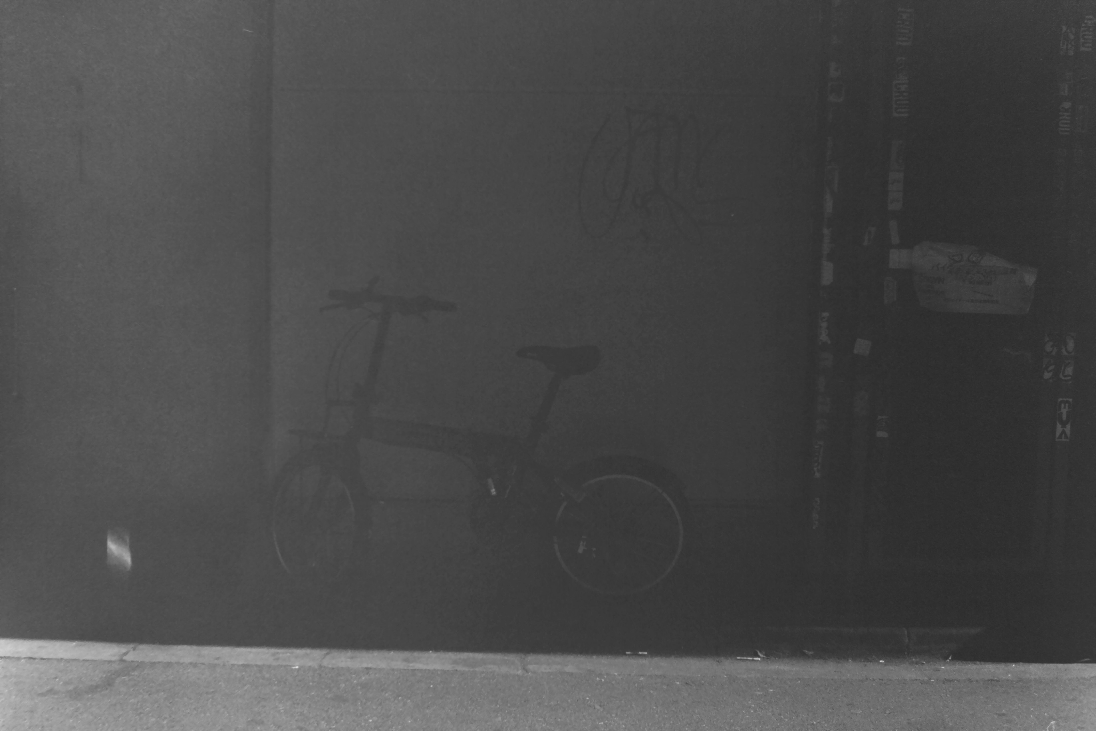 Silhouette of a bicycle against a dim background