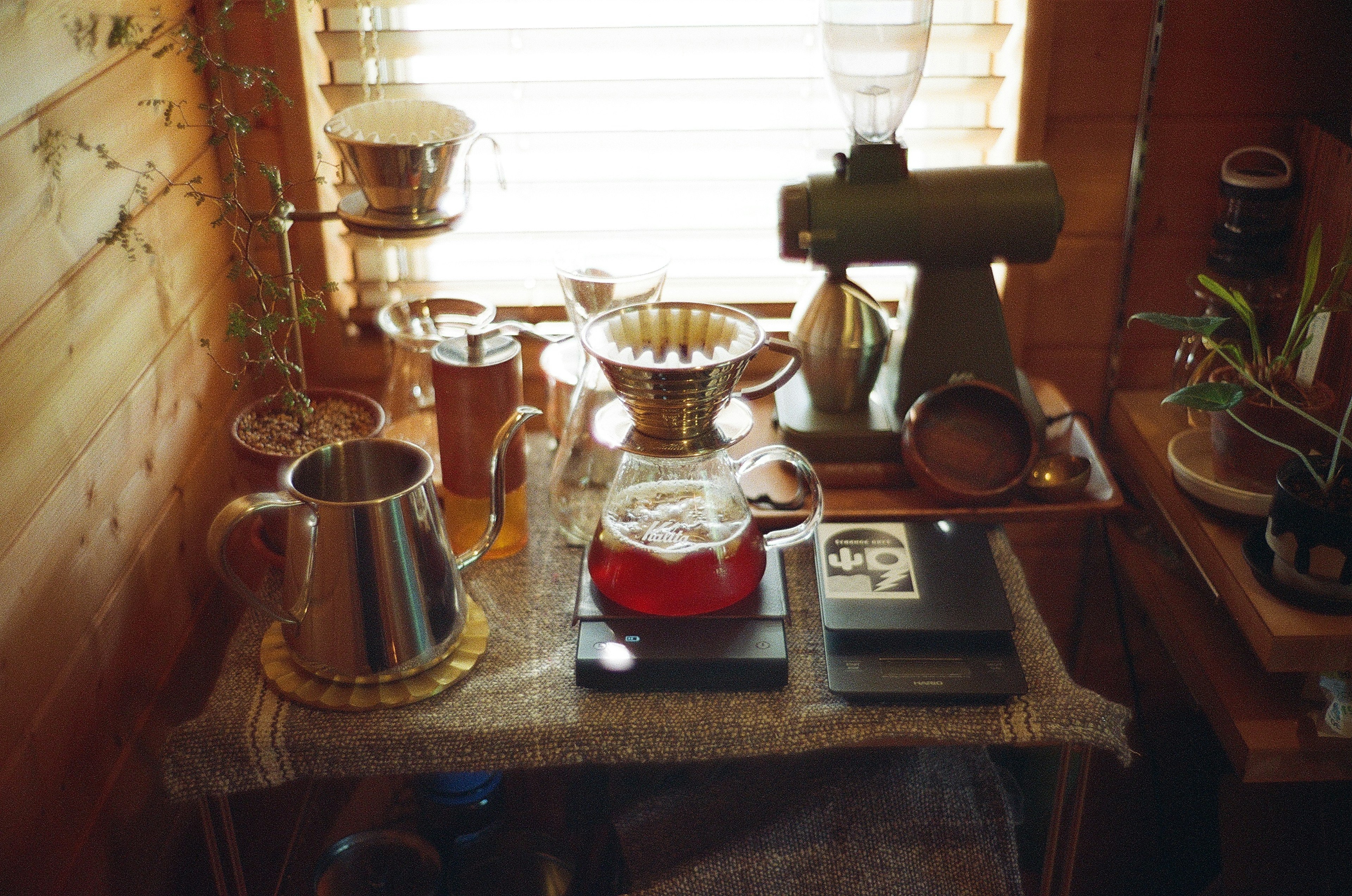 Coffee brewing equipment and beverages on a wooden table