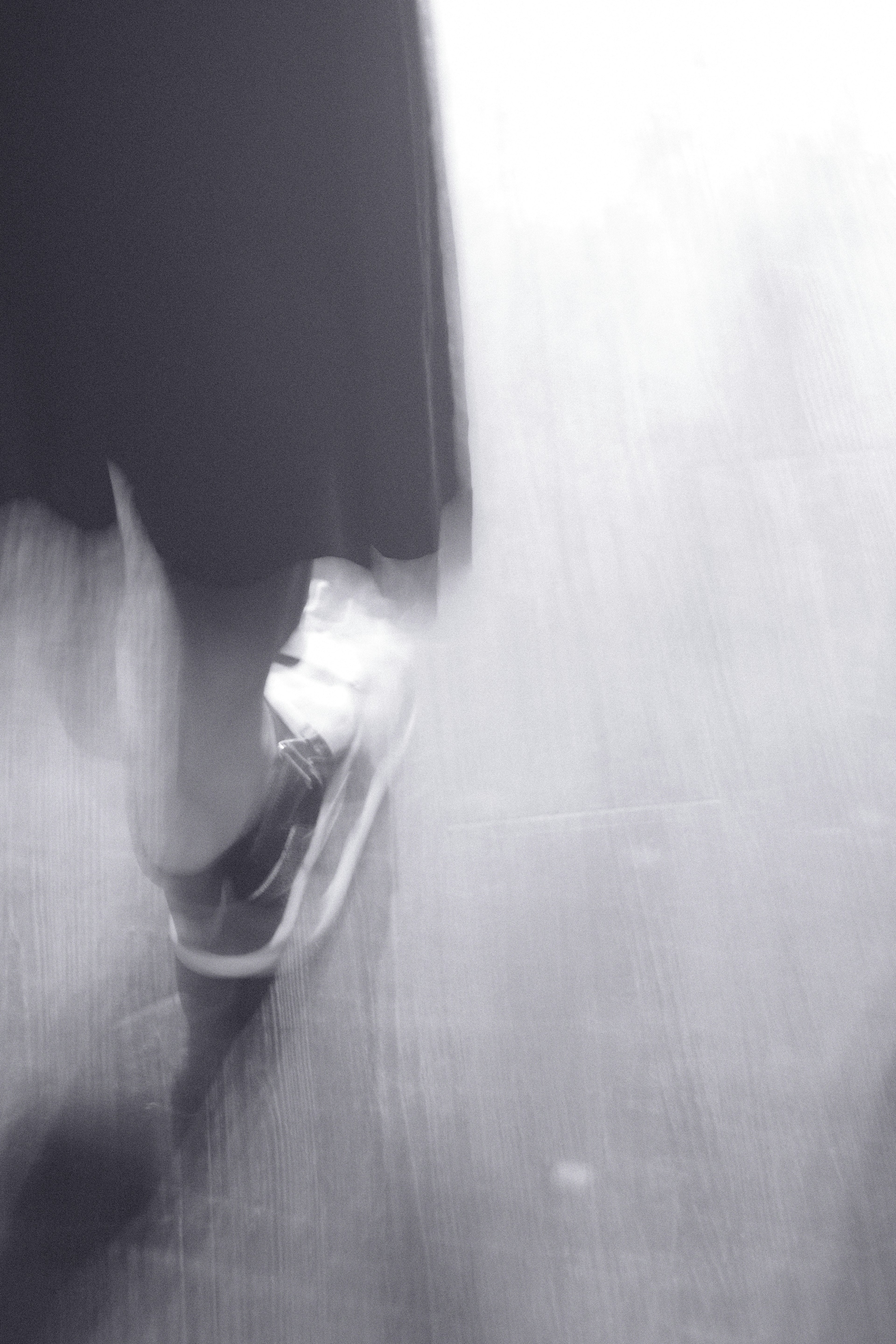 Blurred feet captured in a monochrome photograph