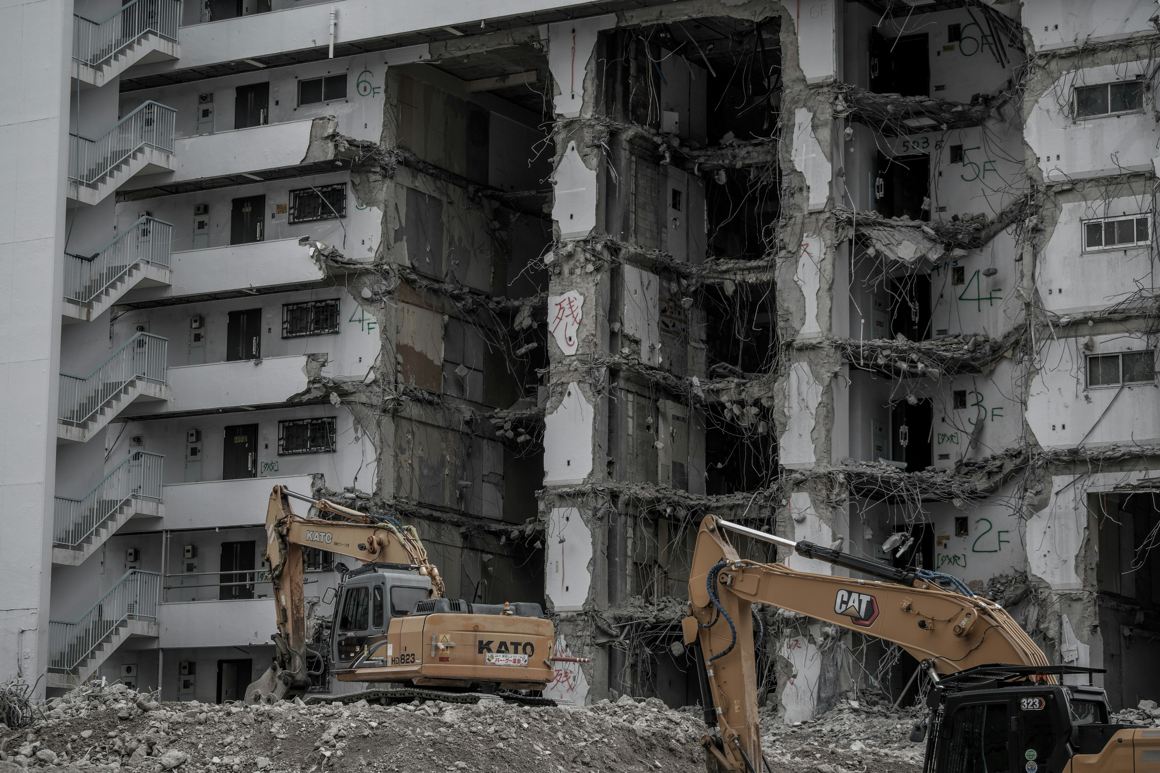 Demolished building with excavators on site