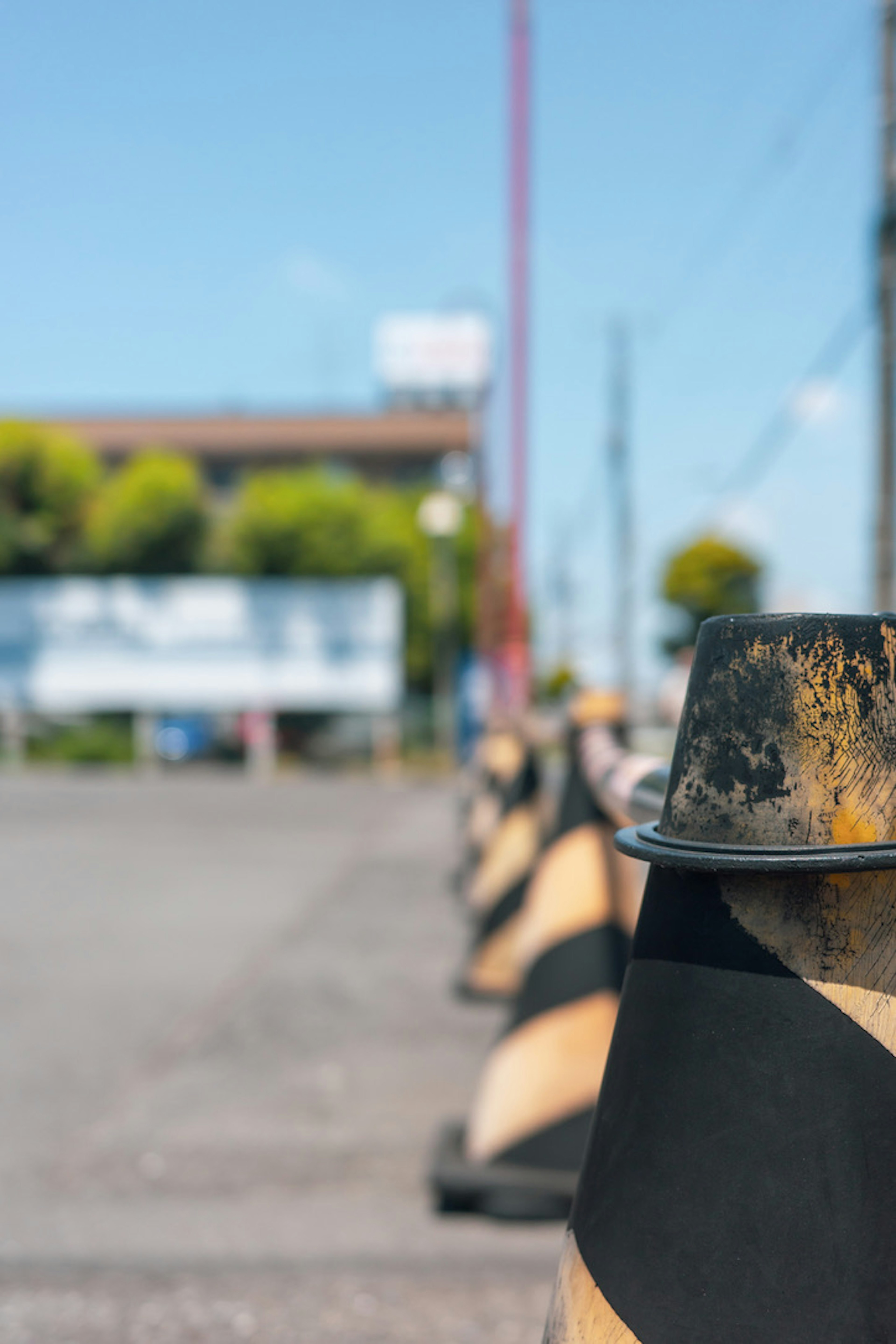 A row of black and orange traffic cones along a road