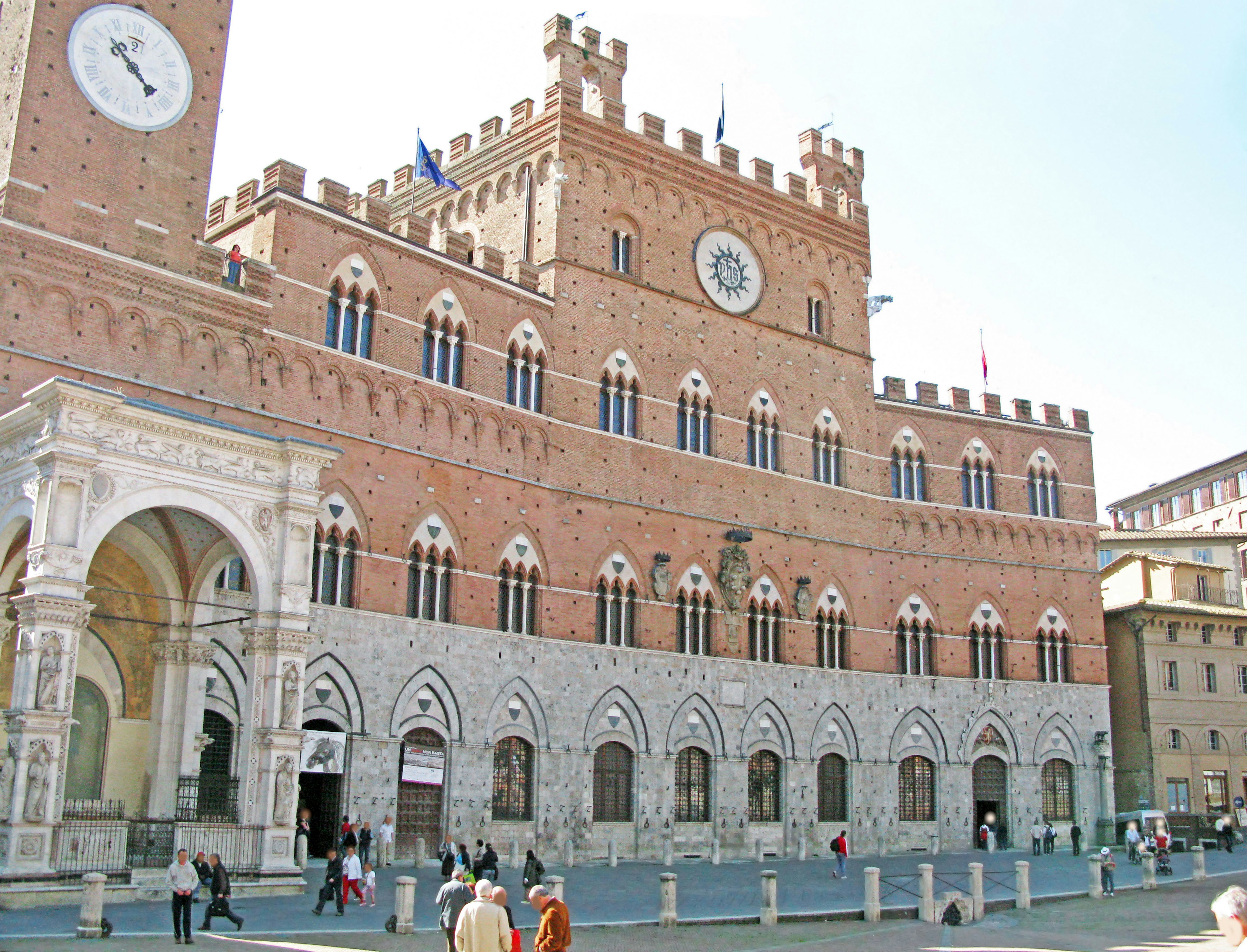 Beautiful brick building in a medieval architectural style located in a square