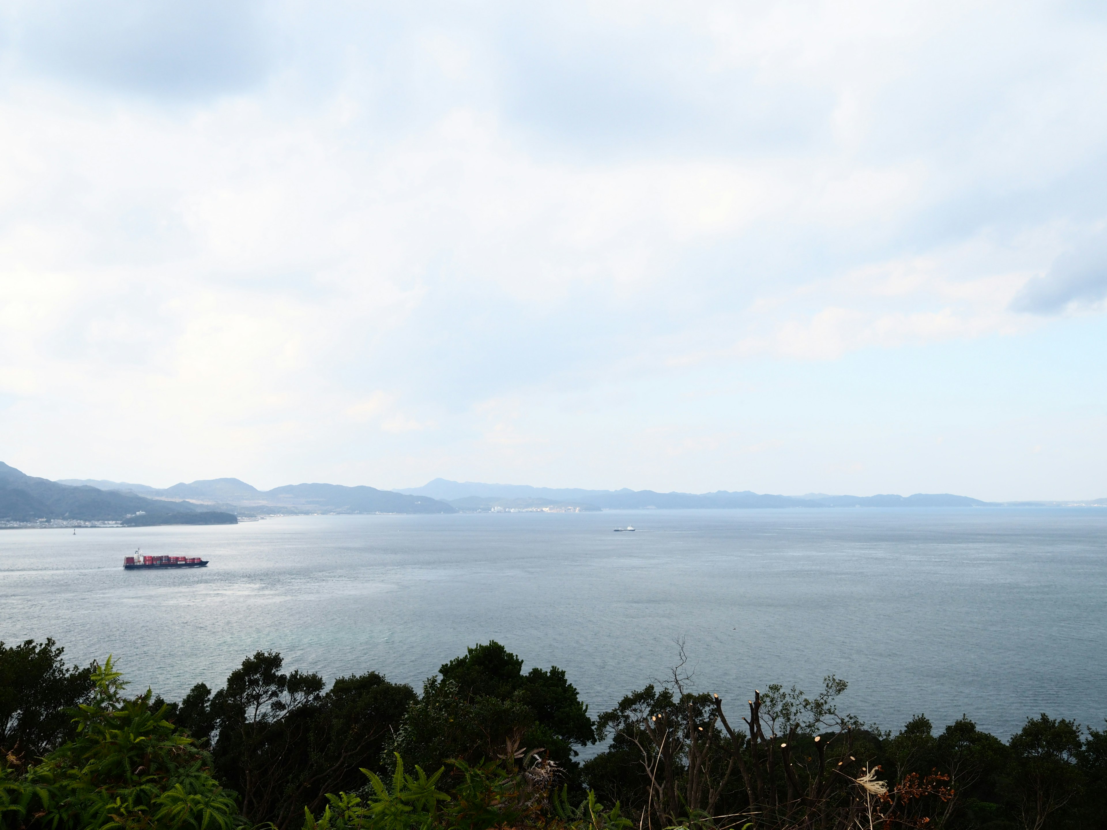 Vue sereine de la mer avec un ciel nuageux un bateau visible au loin