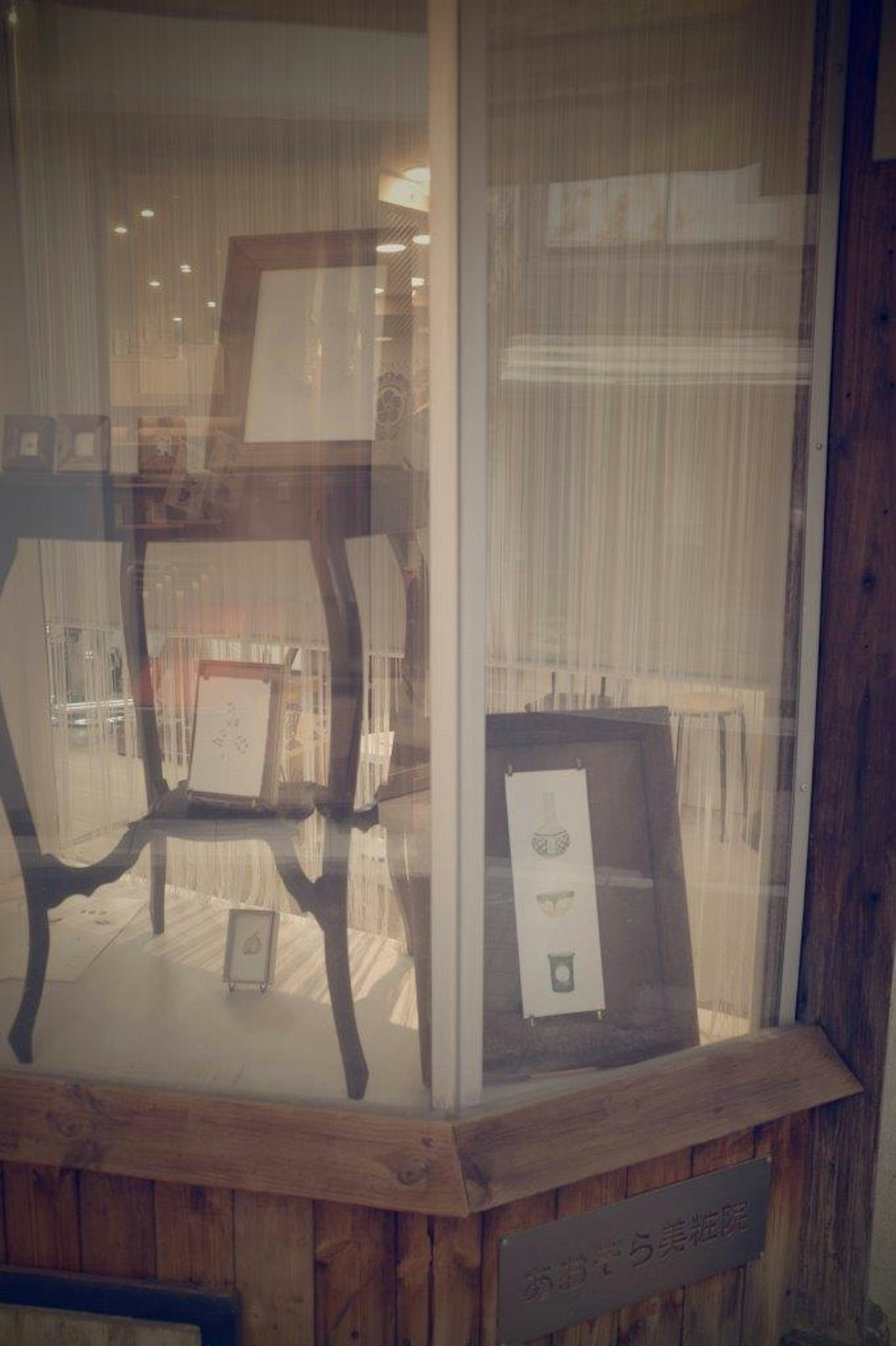 Display window featuring a chair and framed artwork