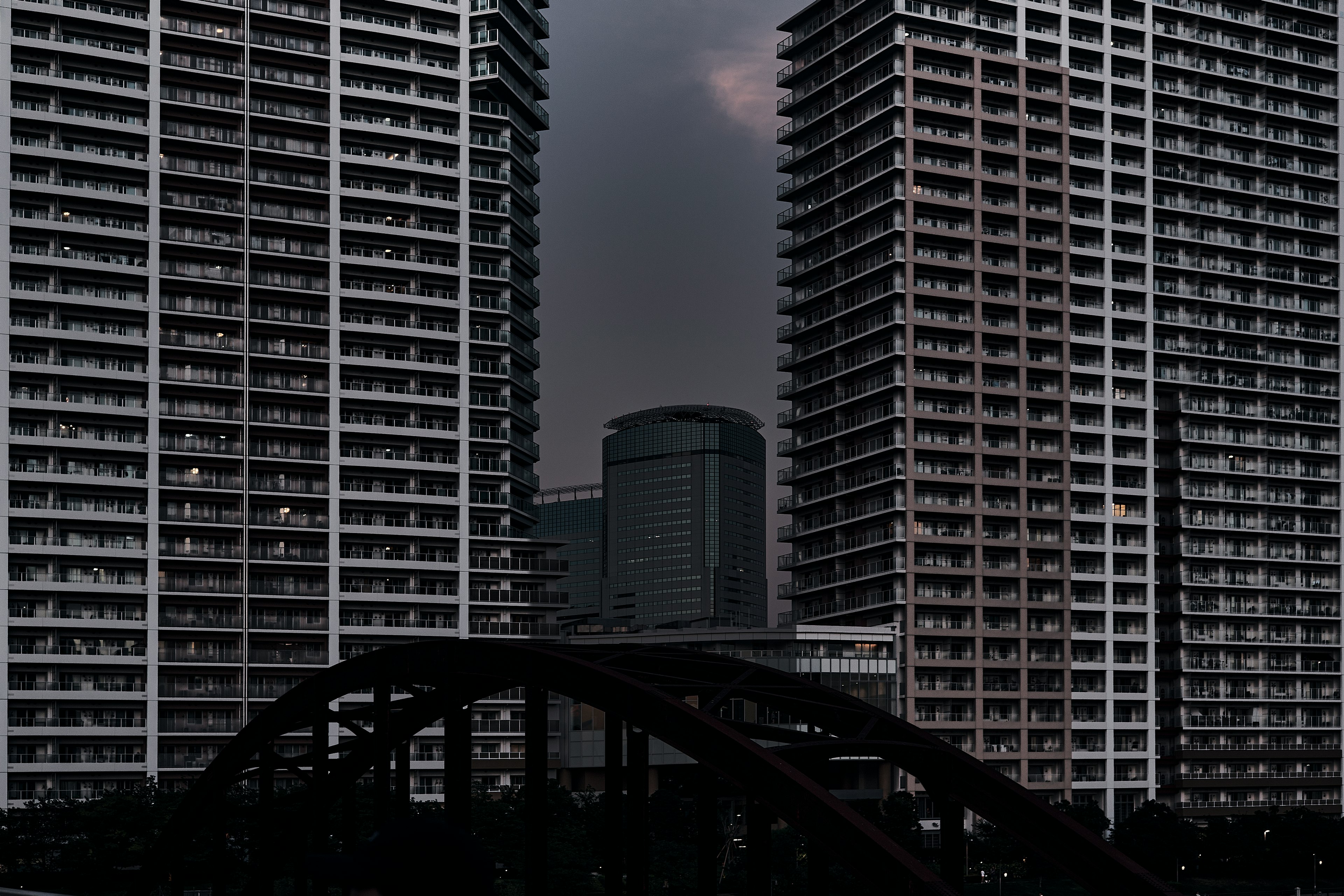 Urban landscape featuring tall buildings and a bridge in the foreground