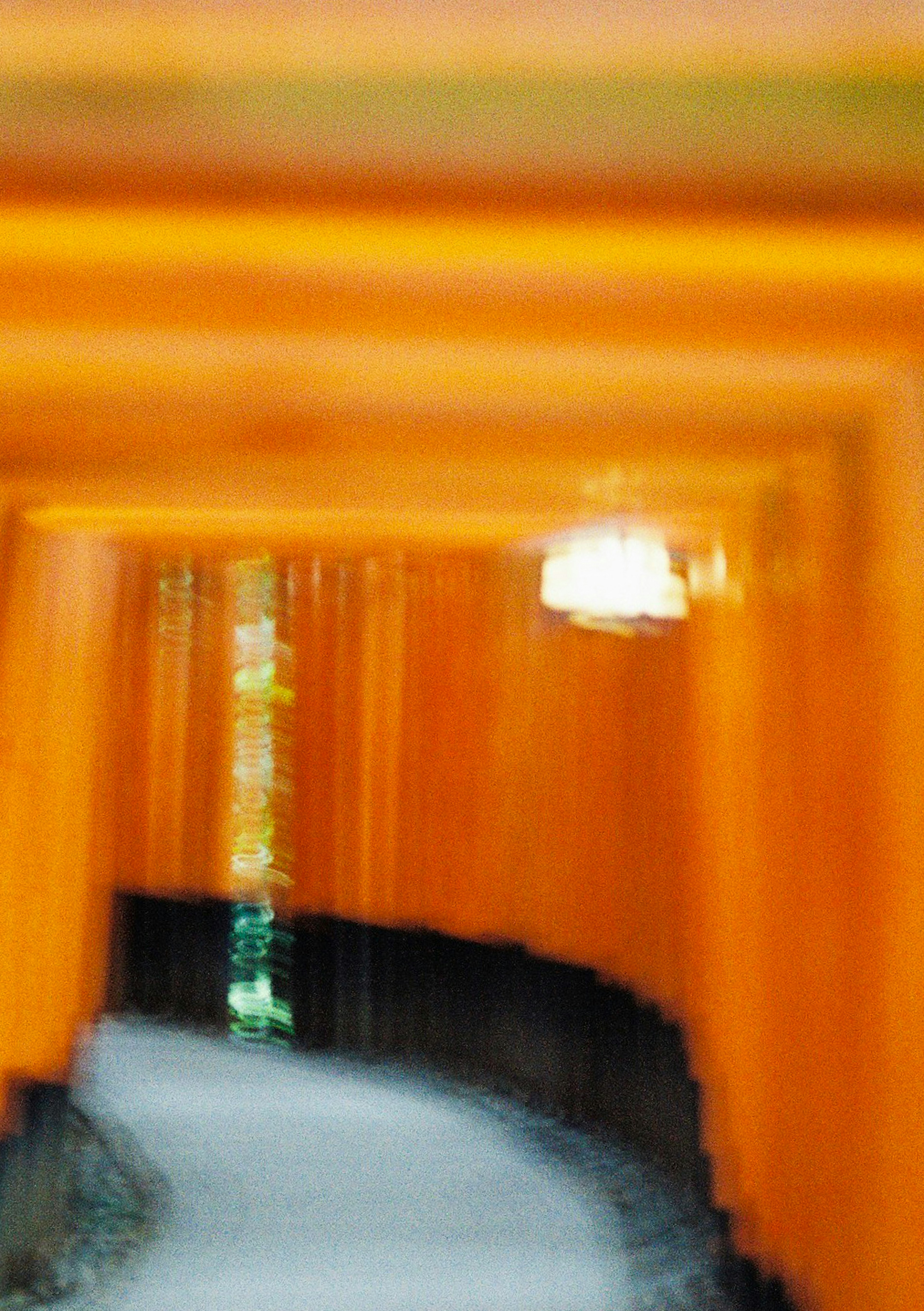 Blurred orange tunnel with green light