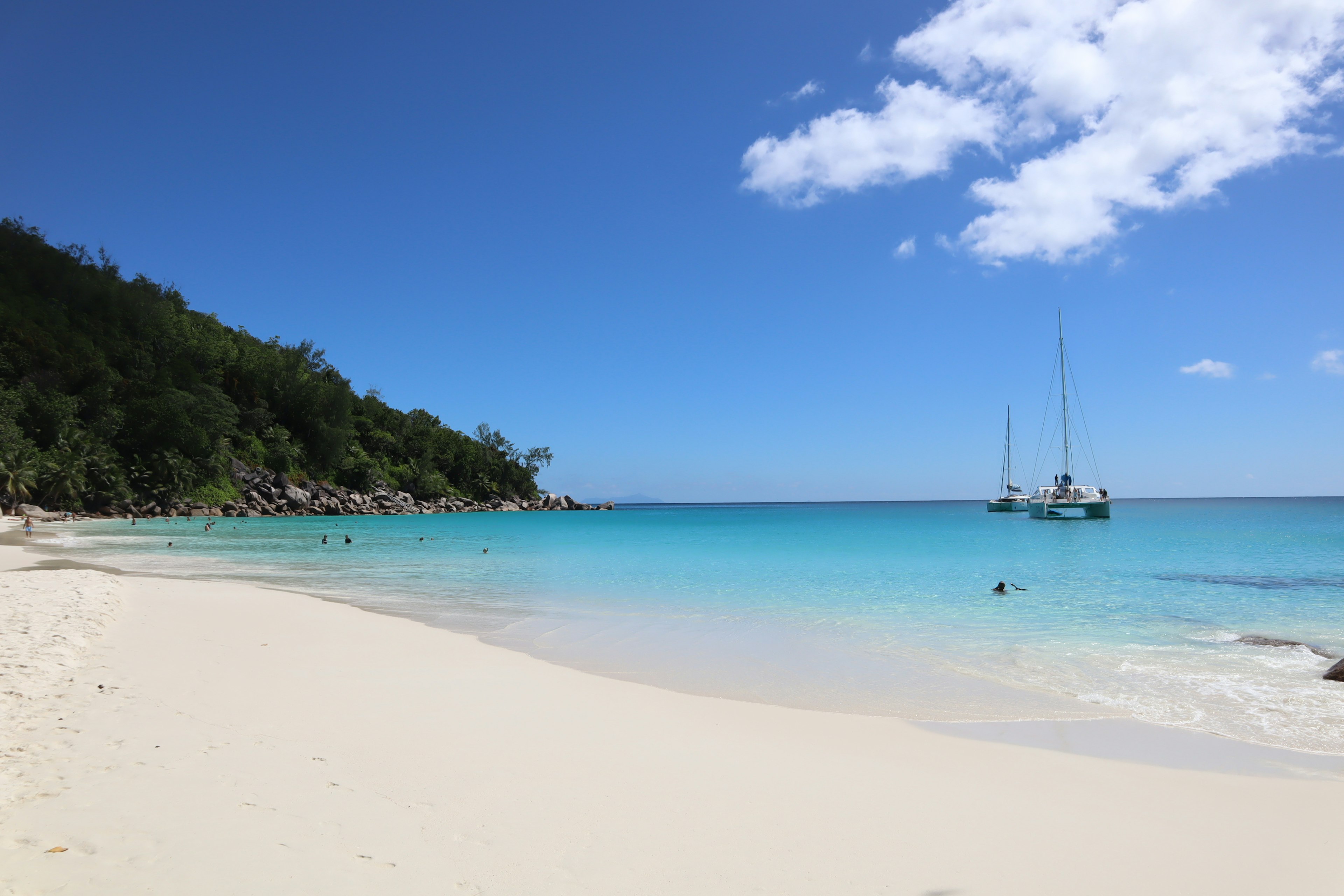 Beautiful beach with blue ocean view and docked boats