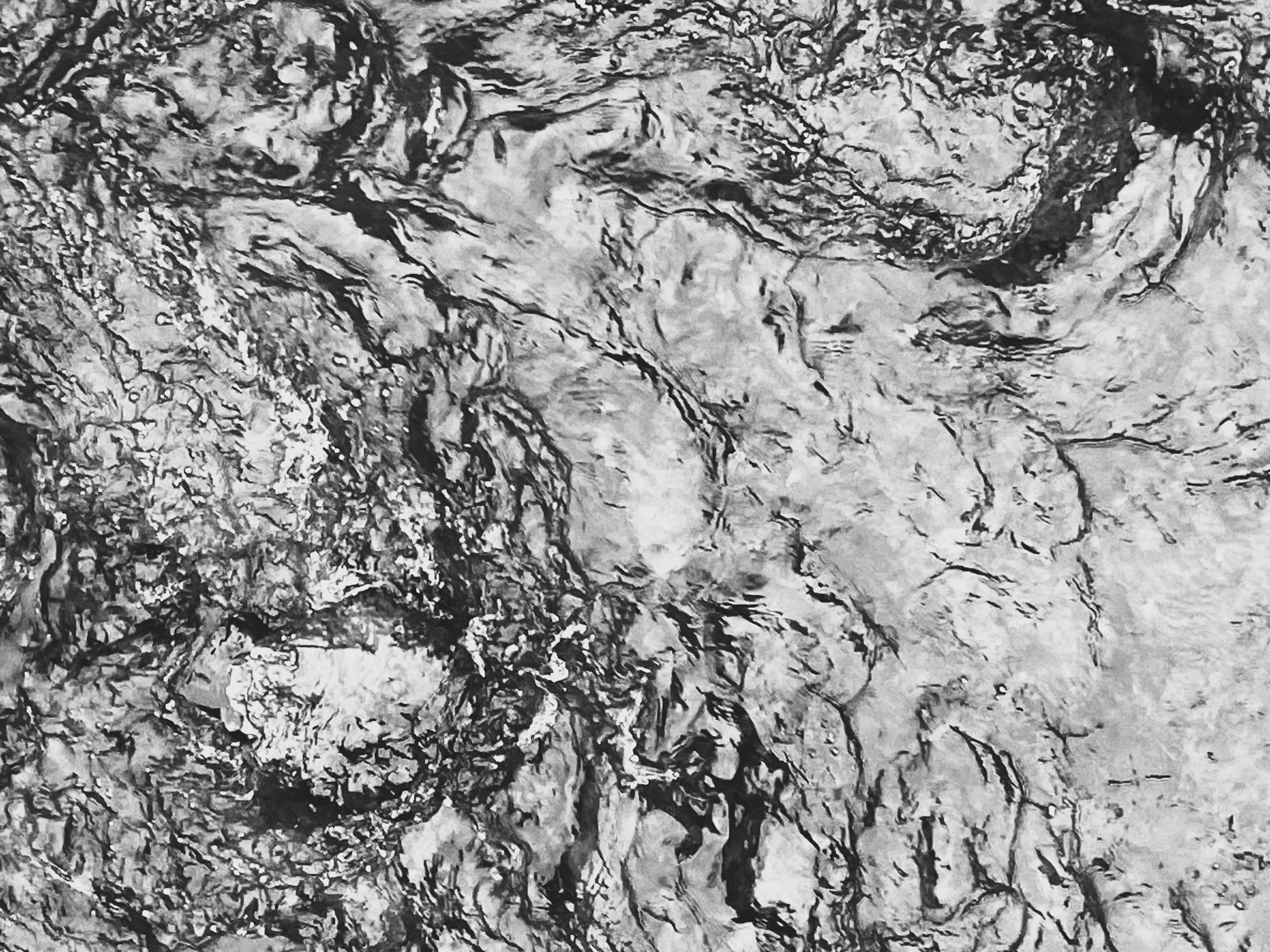 Abstract black and white texture with flowing patterns and various tones