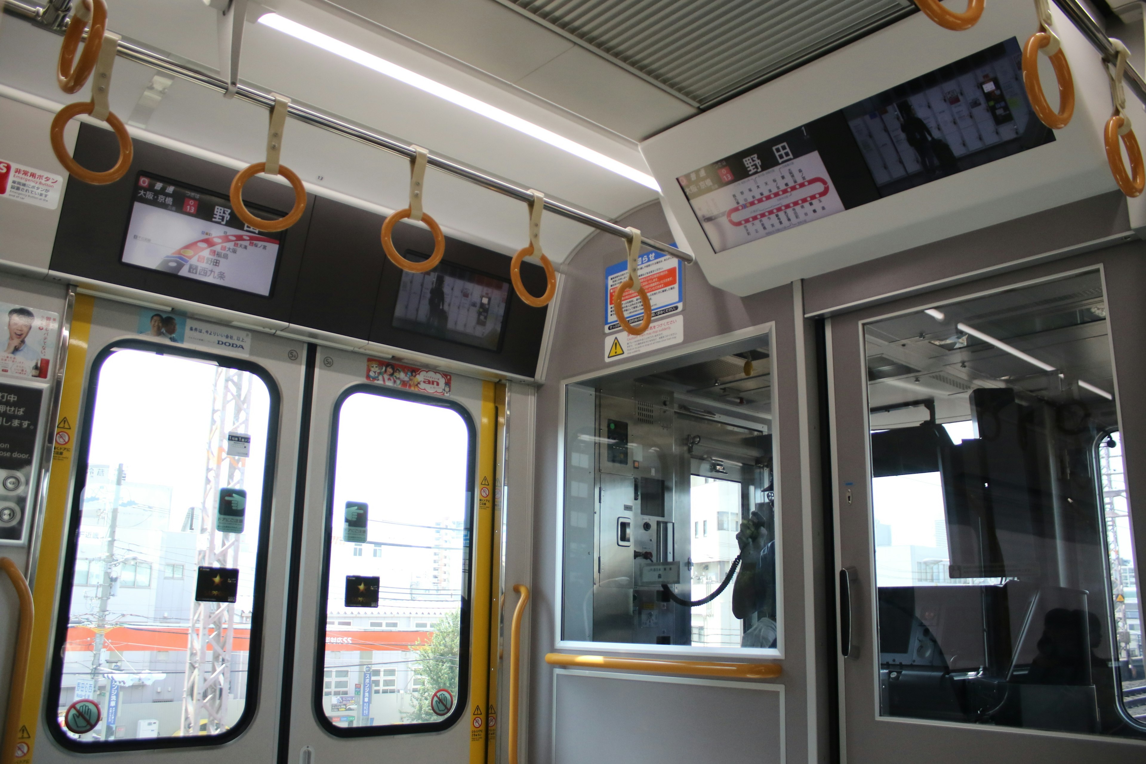 Interior view of a train featuring unique design elements and hanging handles