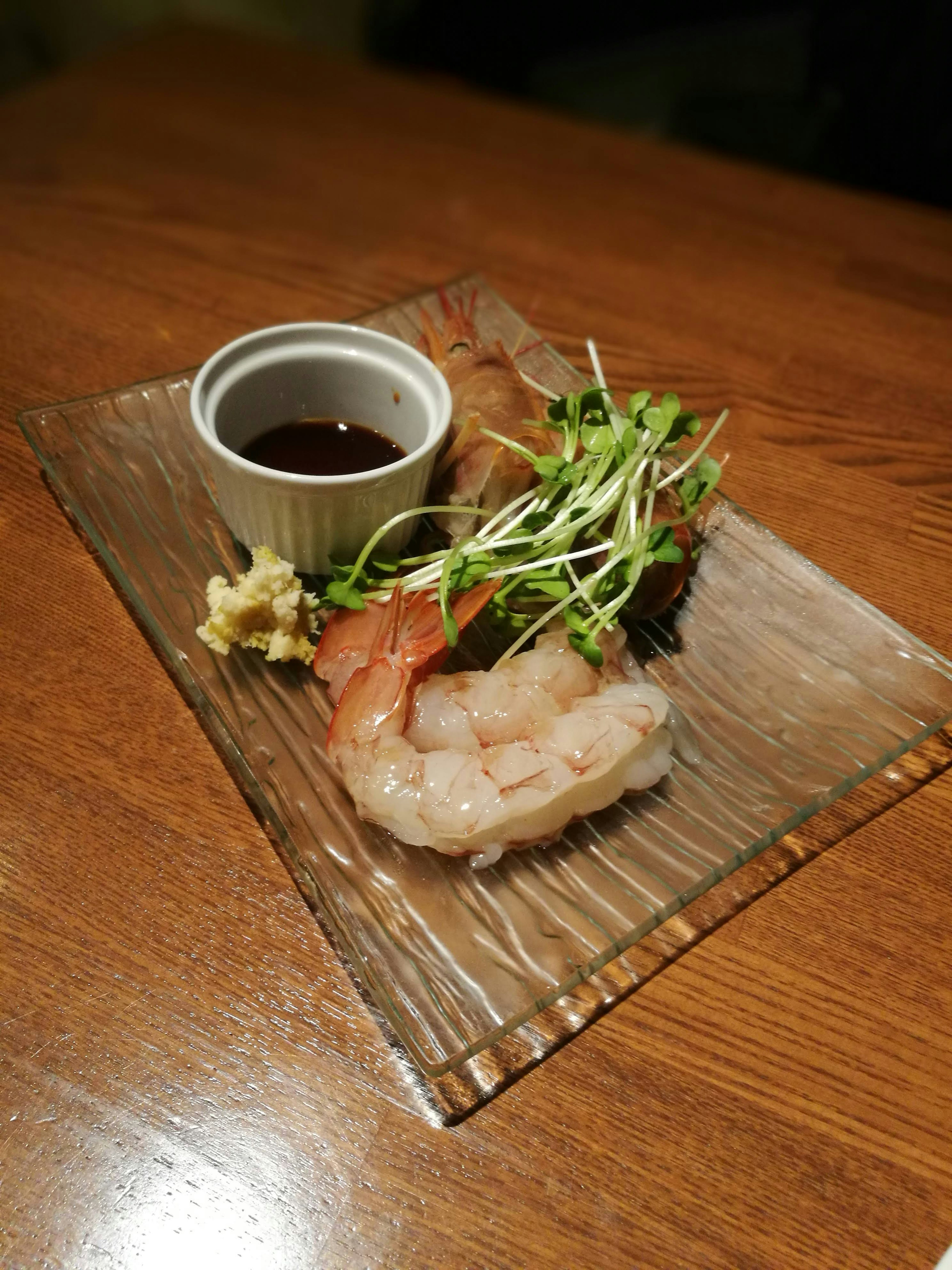 Camarones frescos servidos en un plato con salsa de ensalada de hierbas