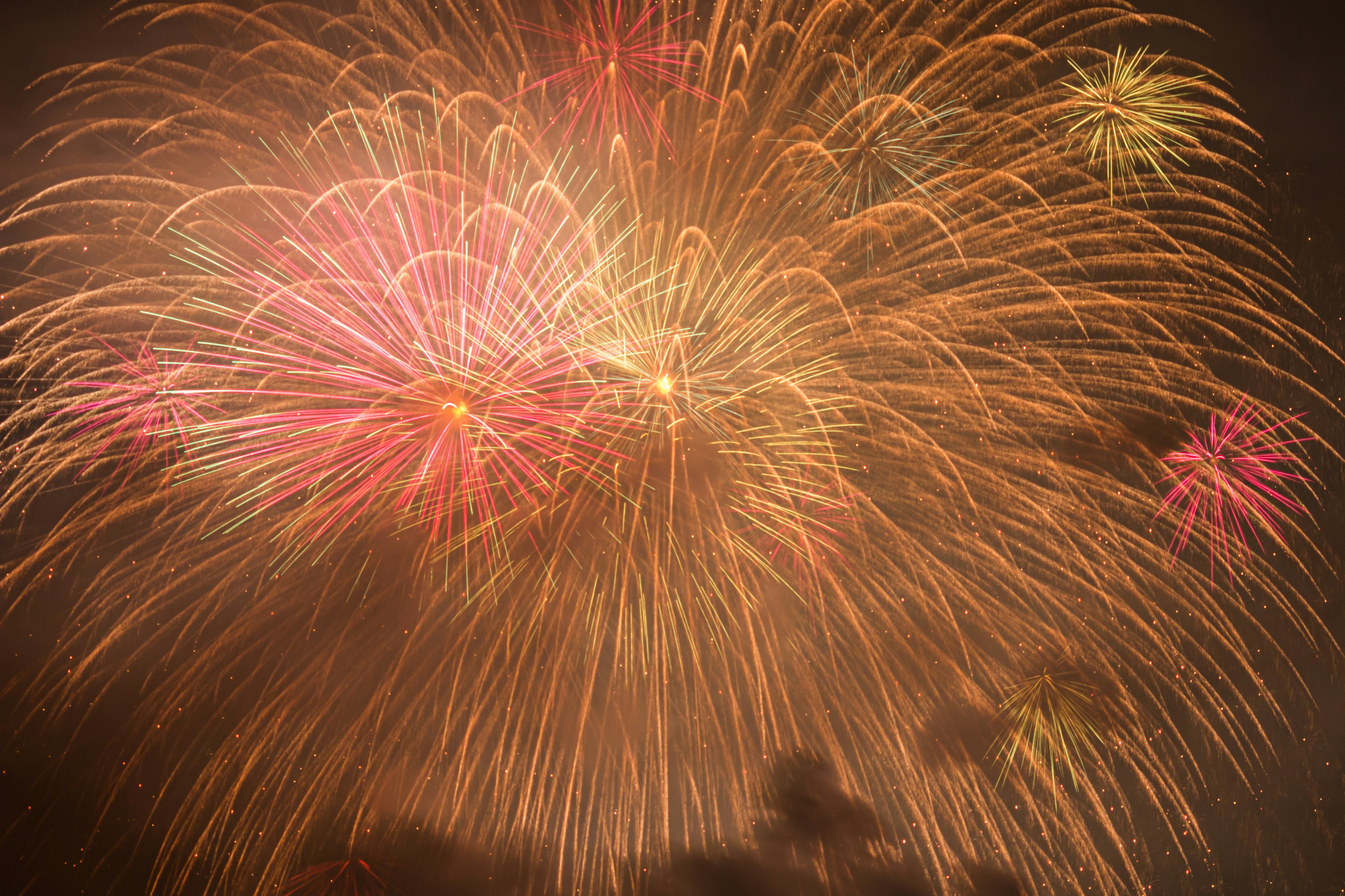 Vibrant fireworks display lighting up the night sky with colorful bursts