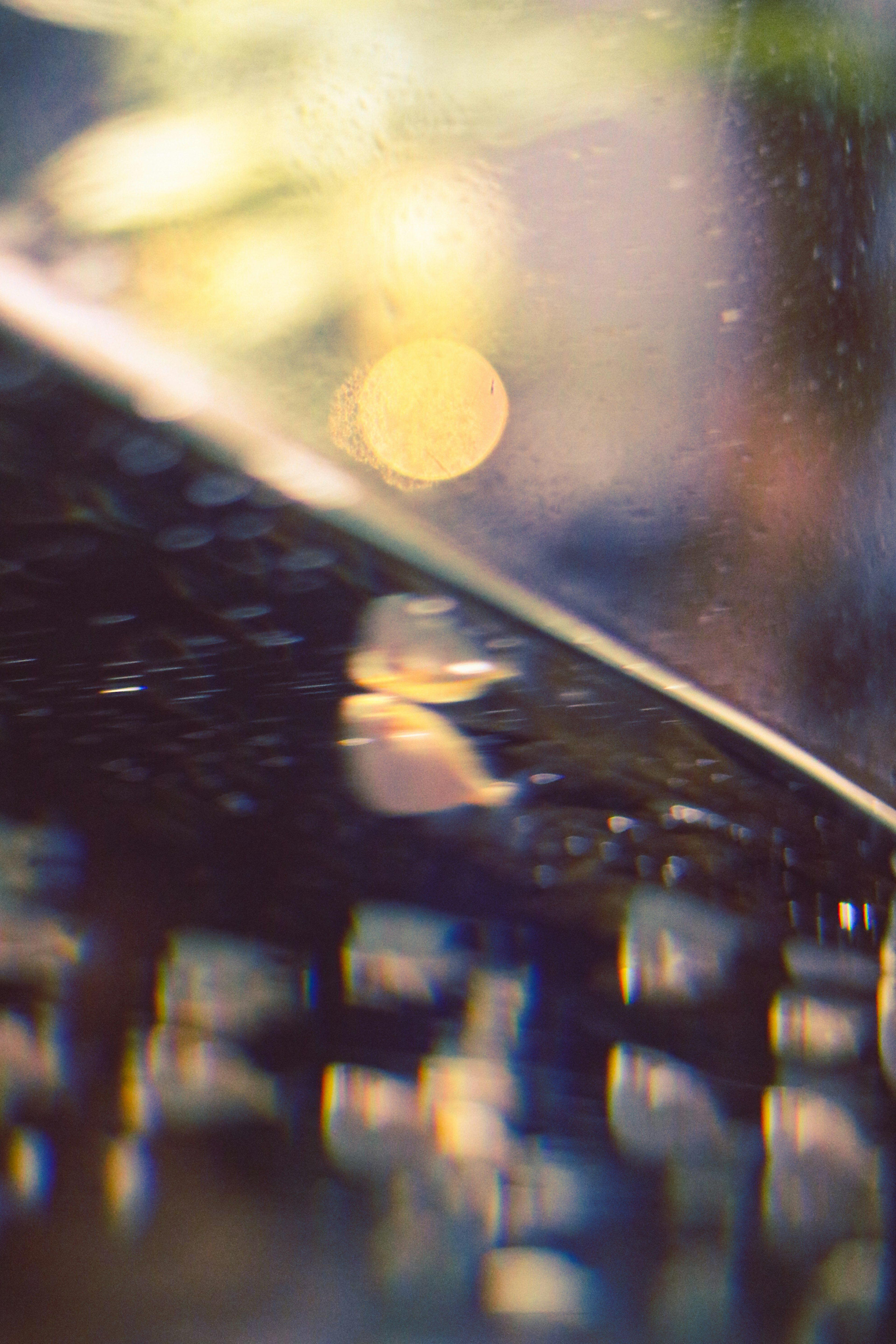 Abstract image featuring a blurred keyboard and reflected light