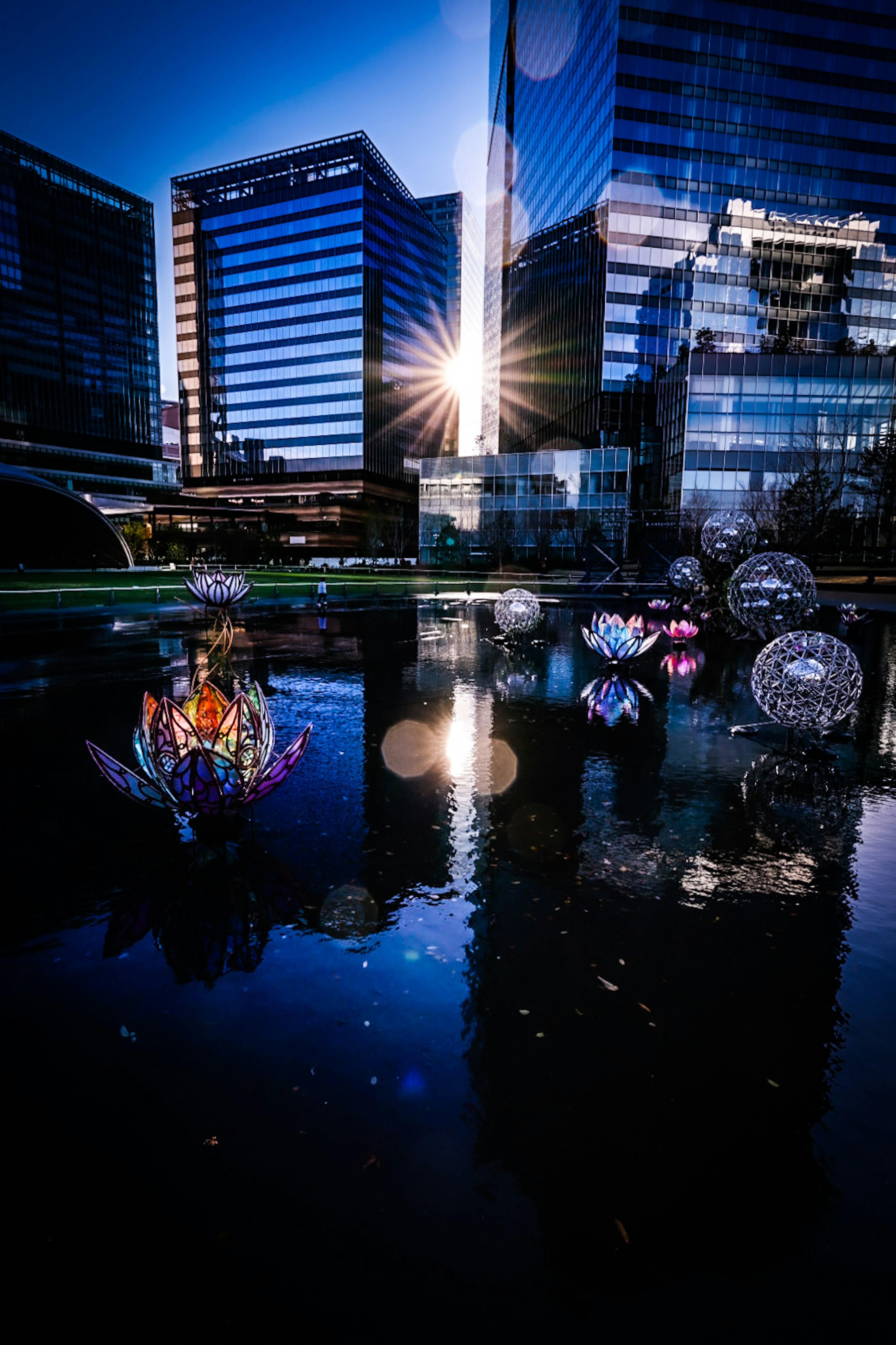 Urban landscape at dusk with reflections of objects on water and skyscrapers