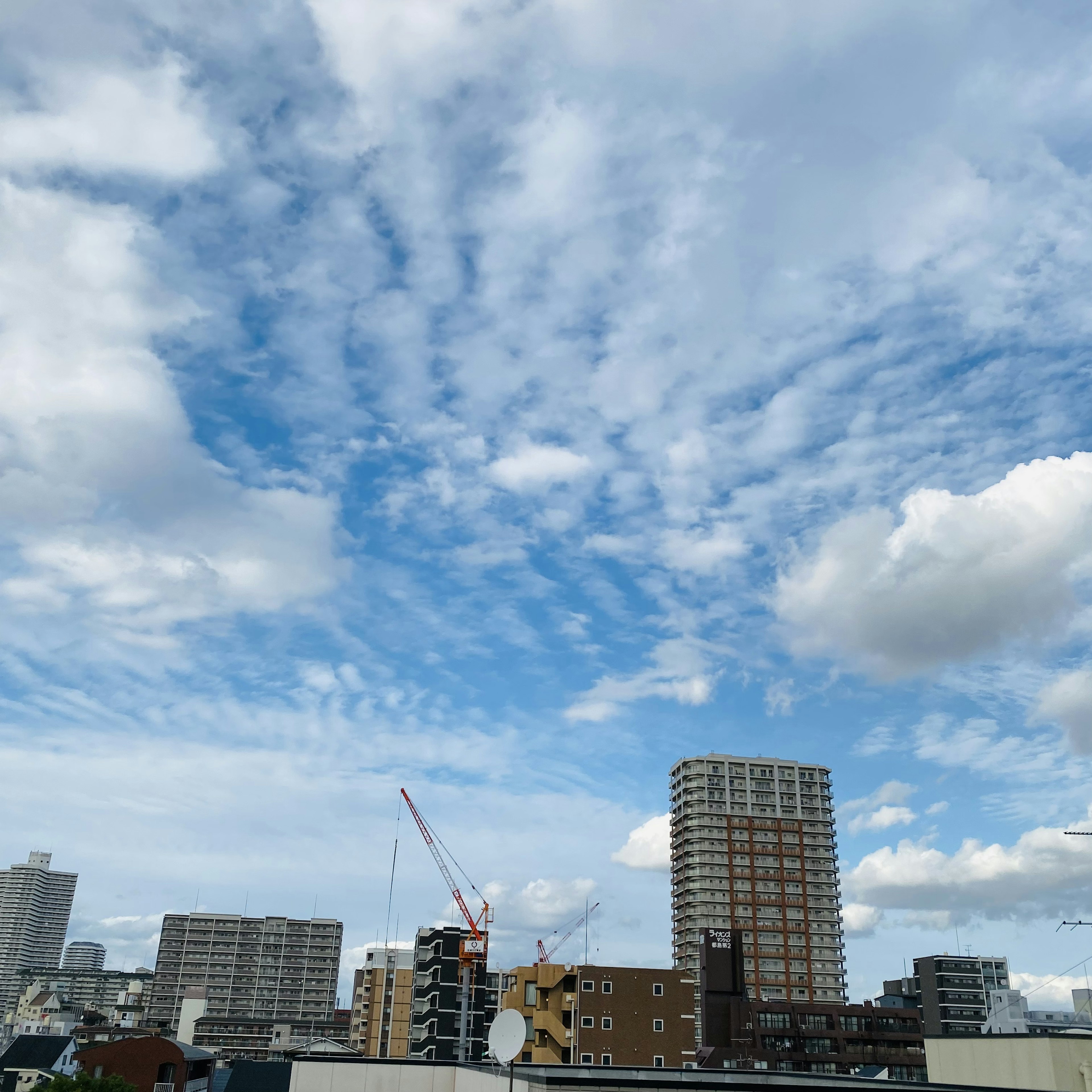 城市景觀，藍天白雲，高樓大廈和吊車