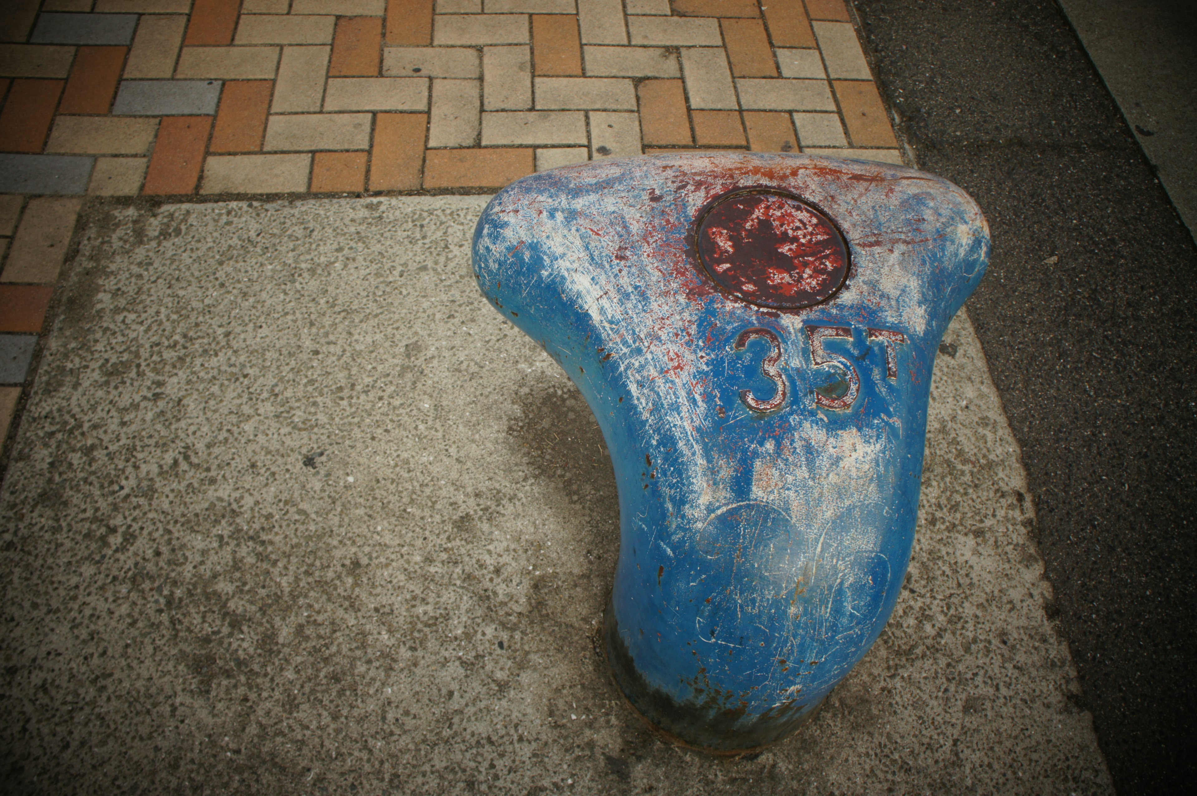 Unique blue concrete block with a red circular mark and the number 357