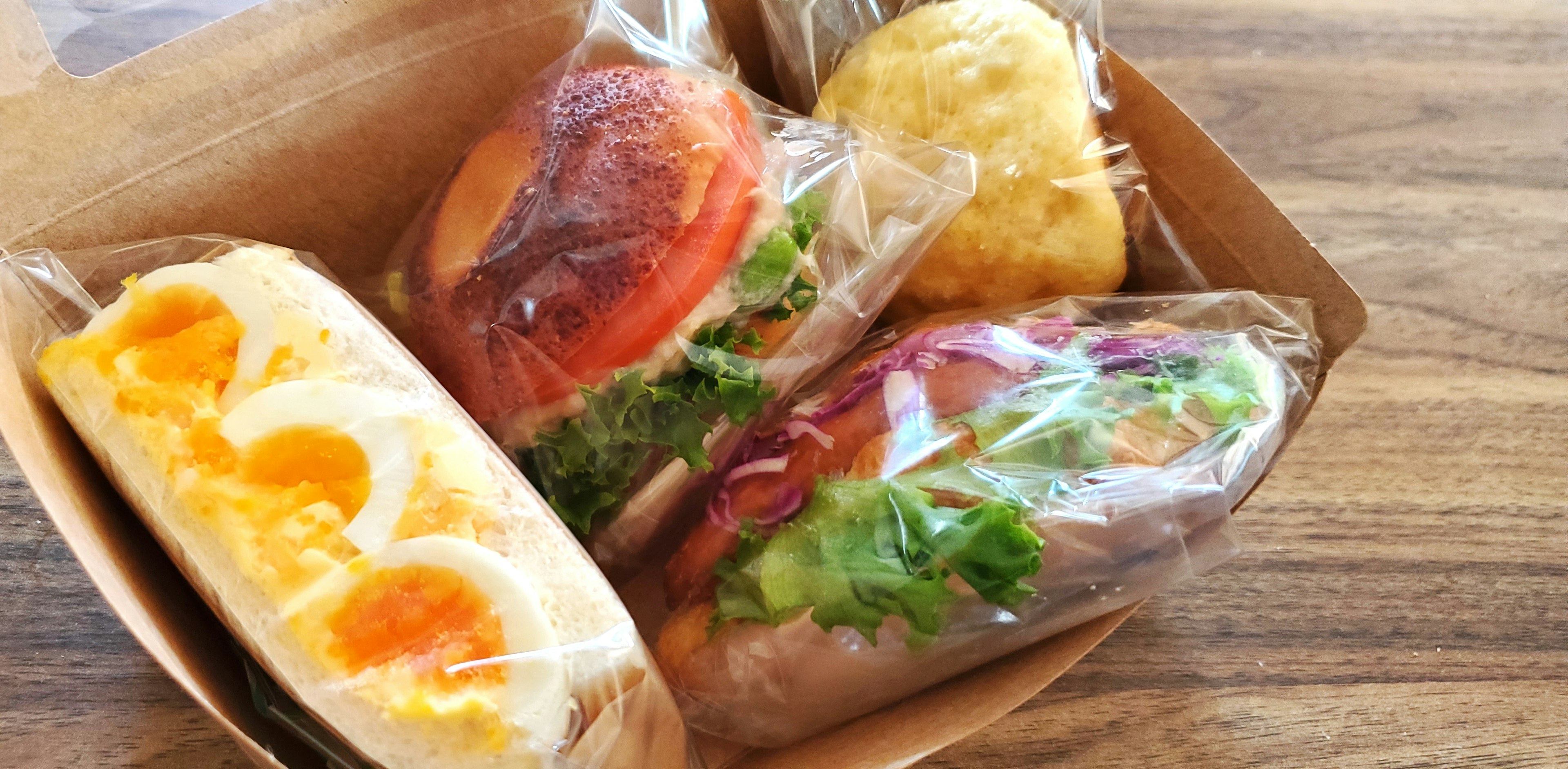 An assortment of colorful sandwiches and eggs wrapped in packaging