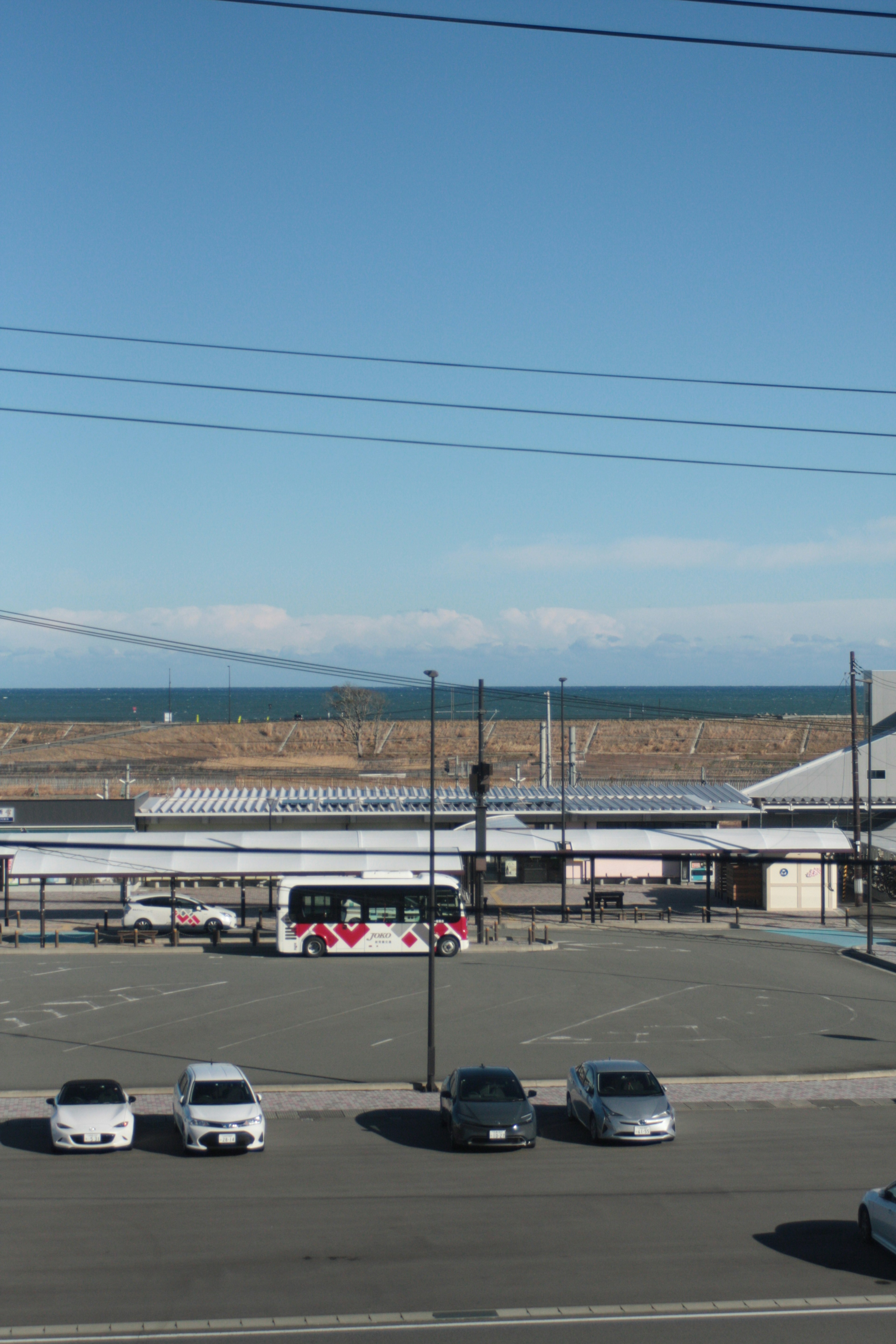 Parking lot with a view of the ocean and surrounding buildings