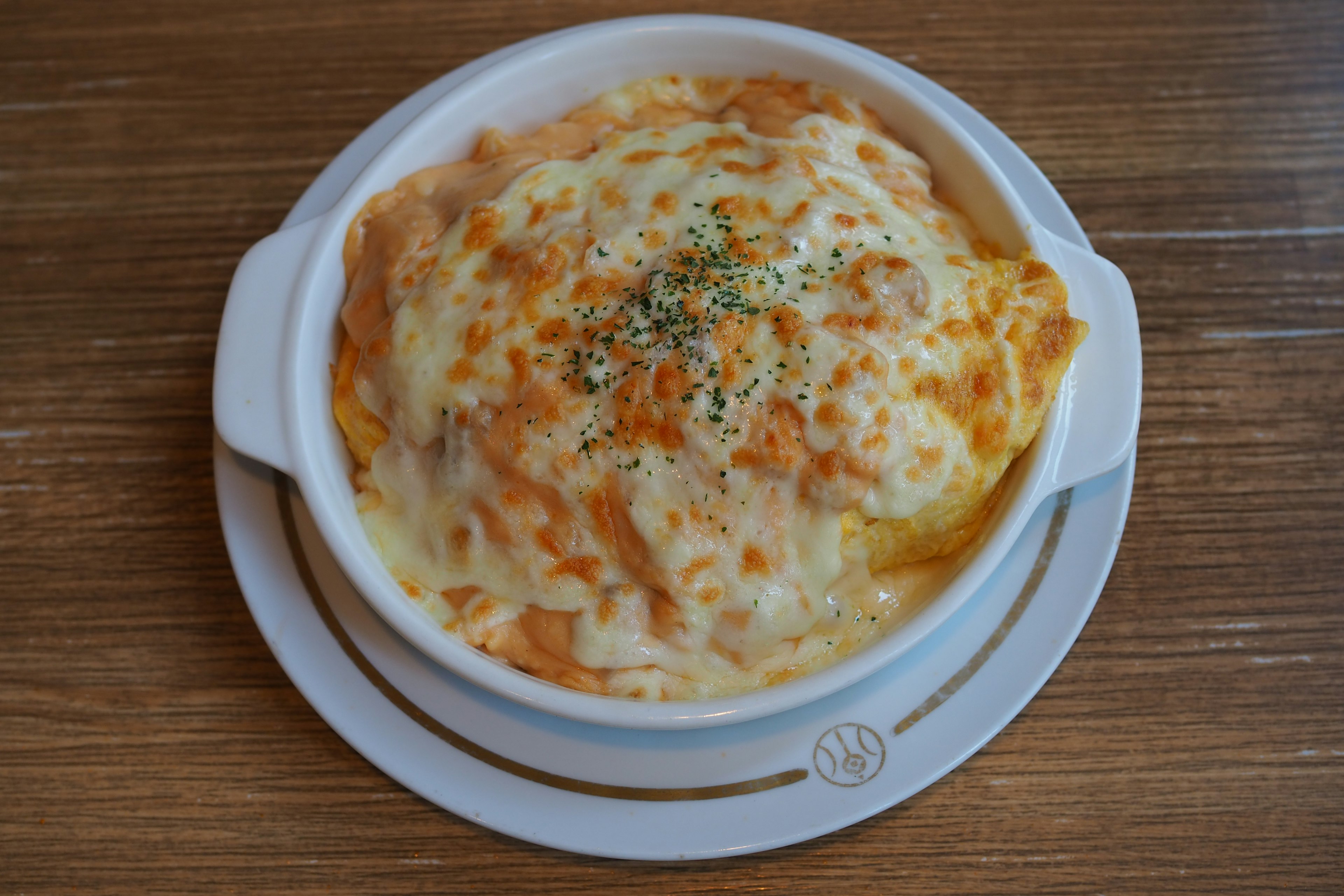 Baked gratin topped with creamy cheese and herbs