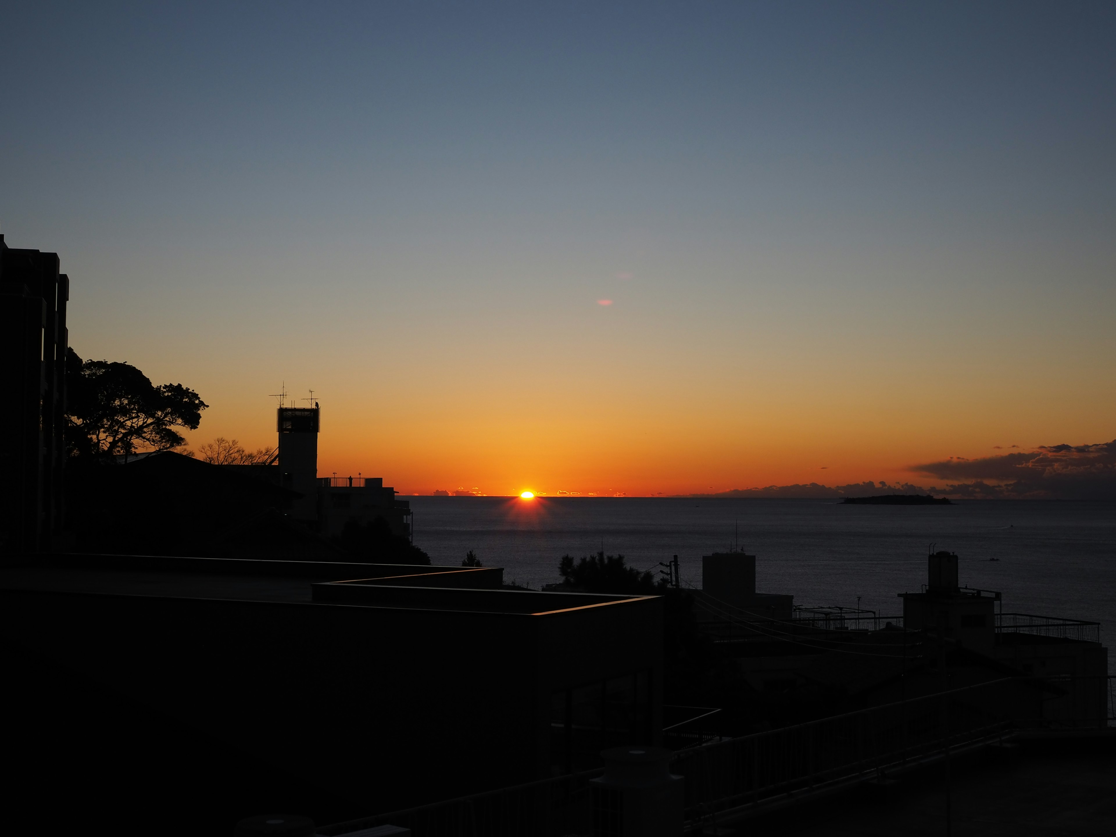 Beautiful landscape with sunset over the horizon and silhouettes