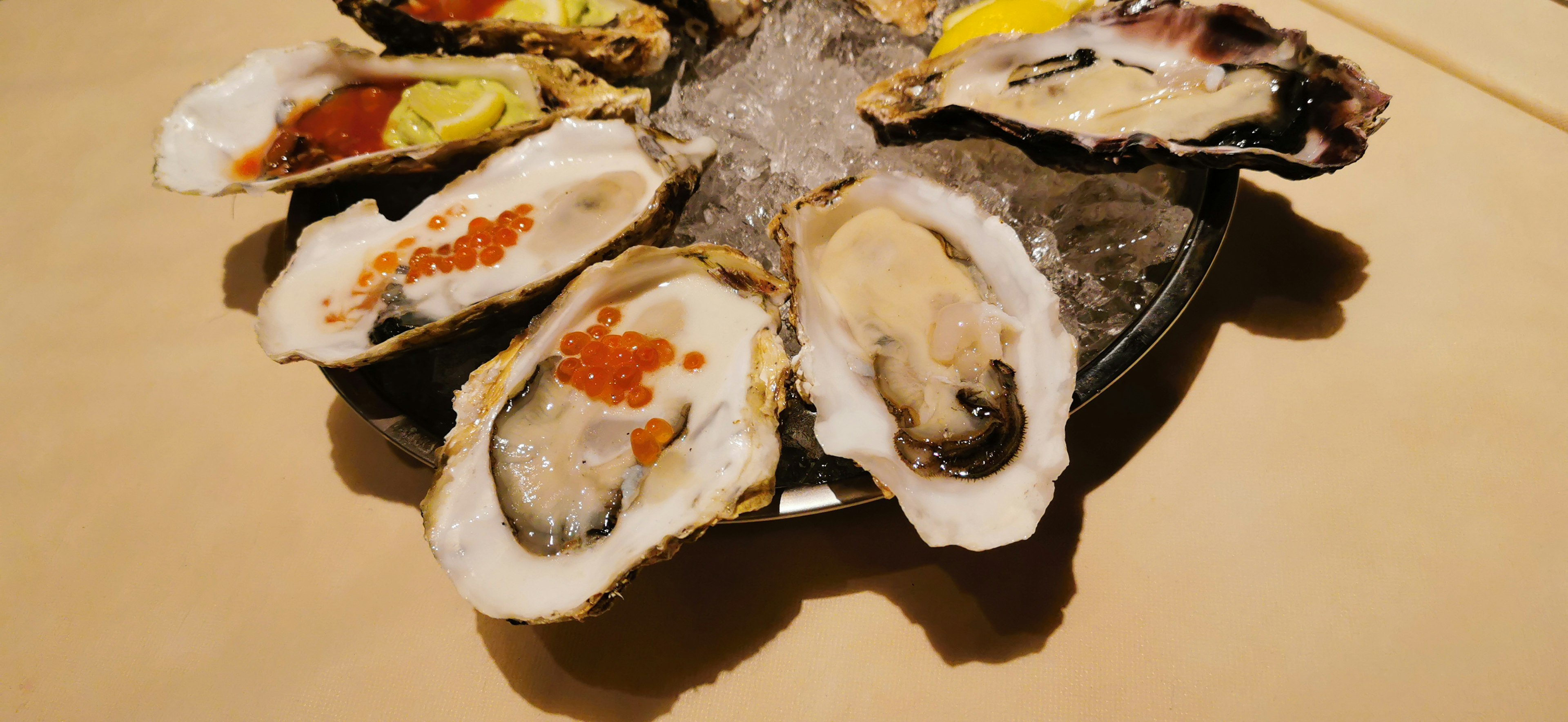 Fresh oysters served on ice with various toppings