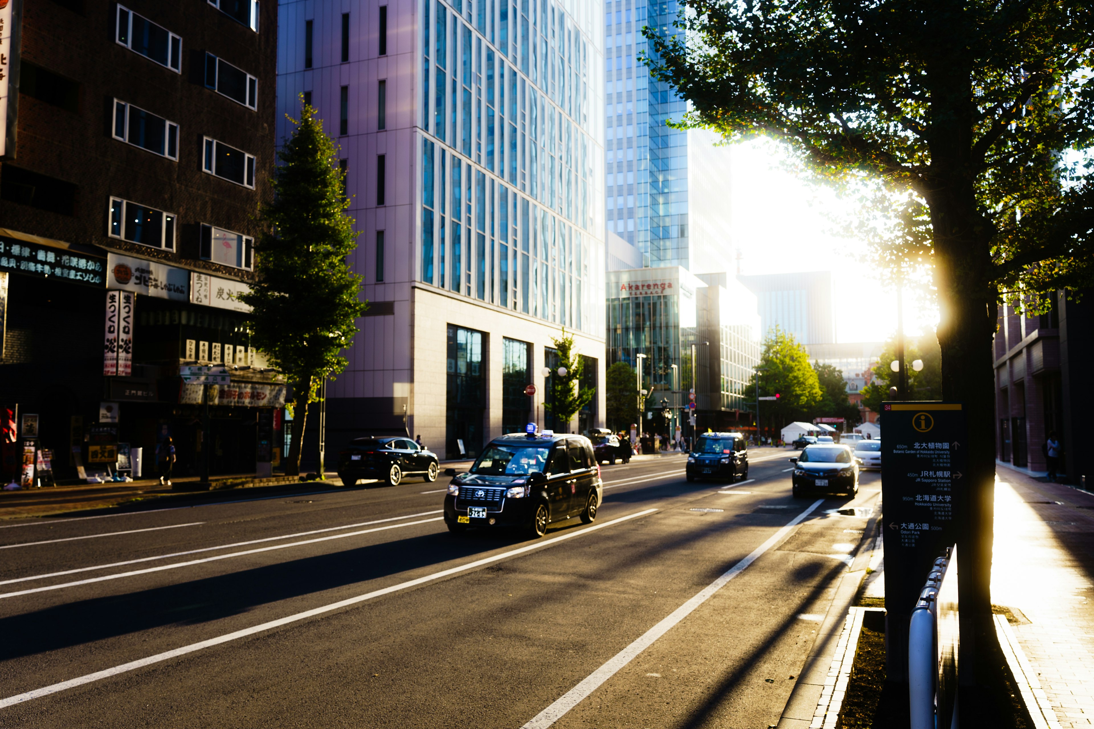 都市の通りに沿った建物と車両の風景