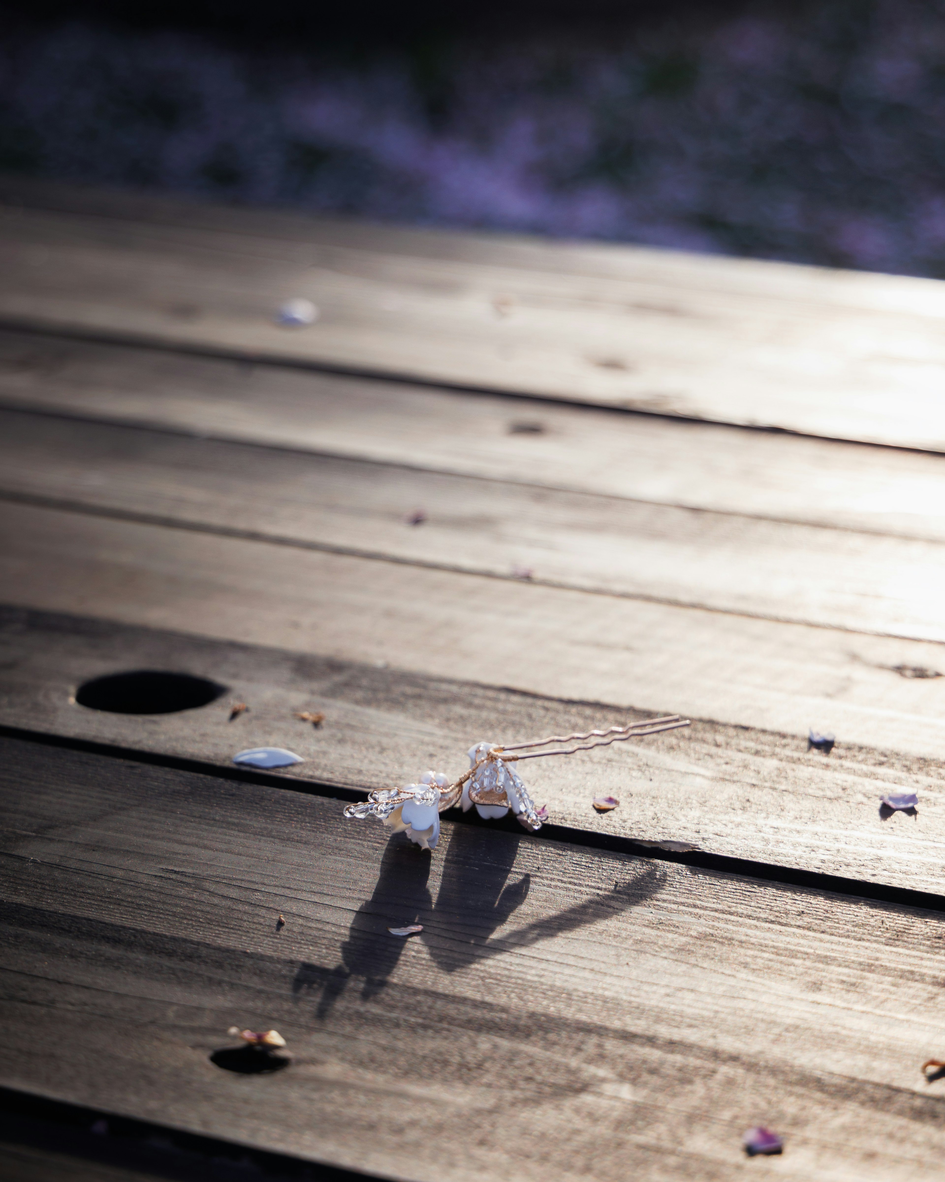 Petals and shadow on a wooden table