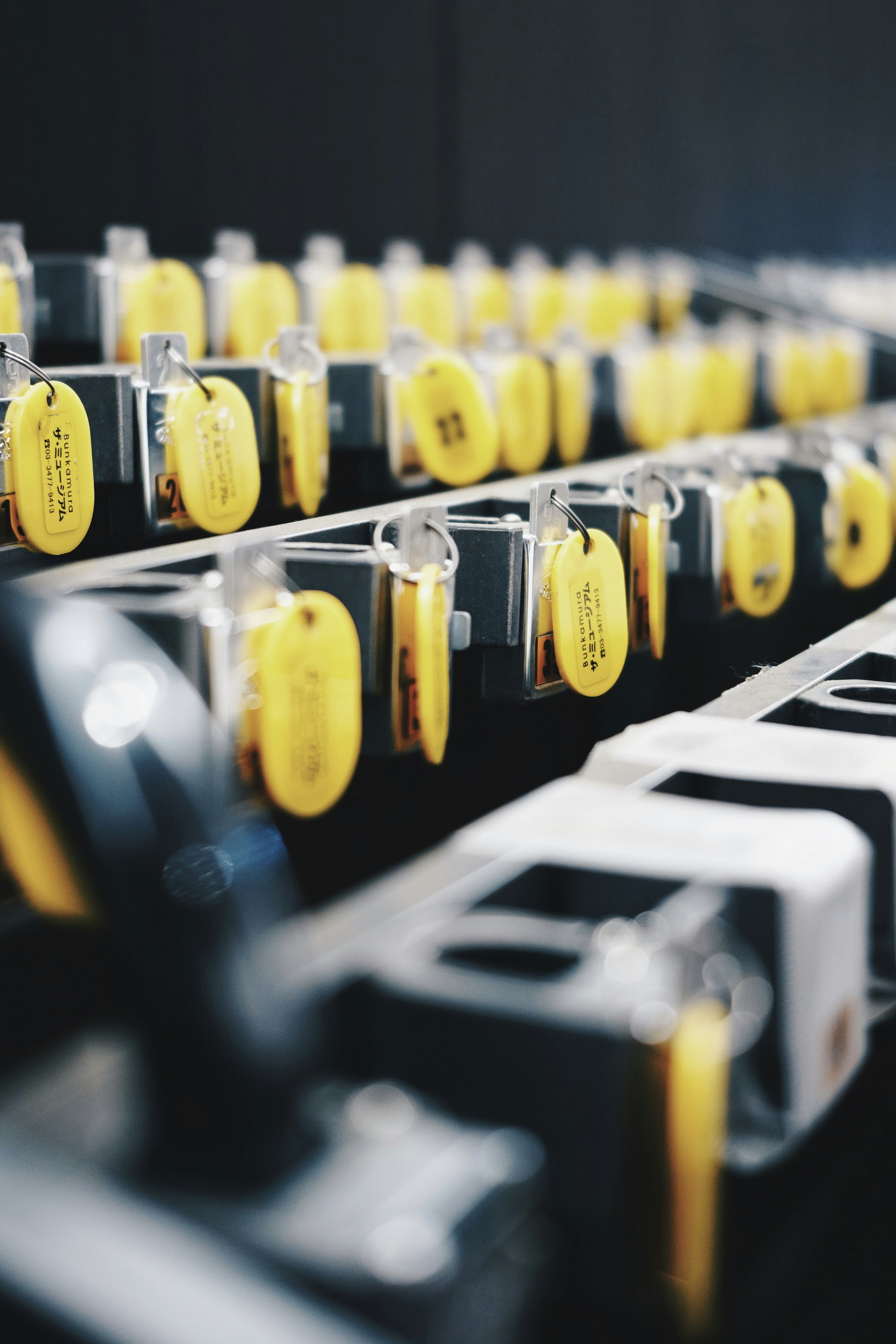 Row of keys with yellow tags against a black background