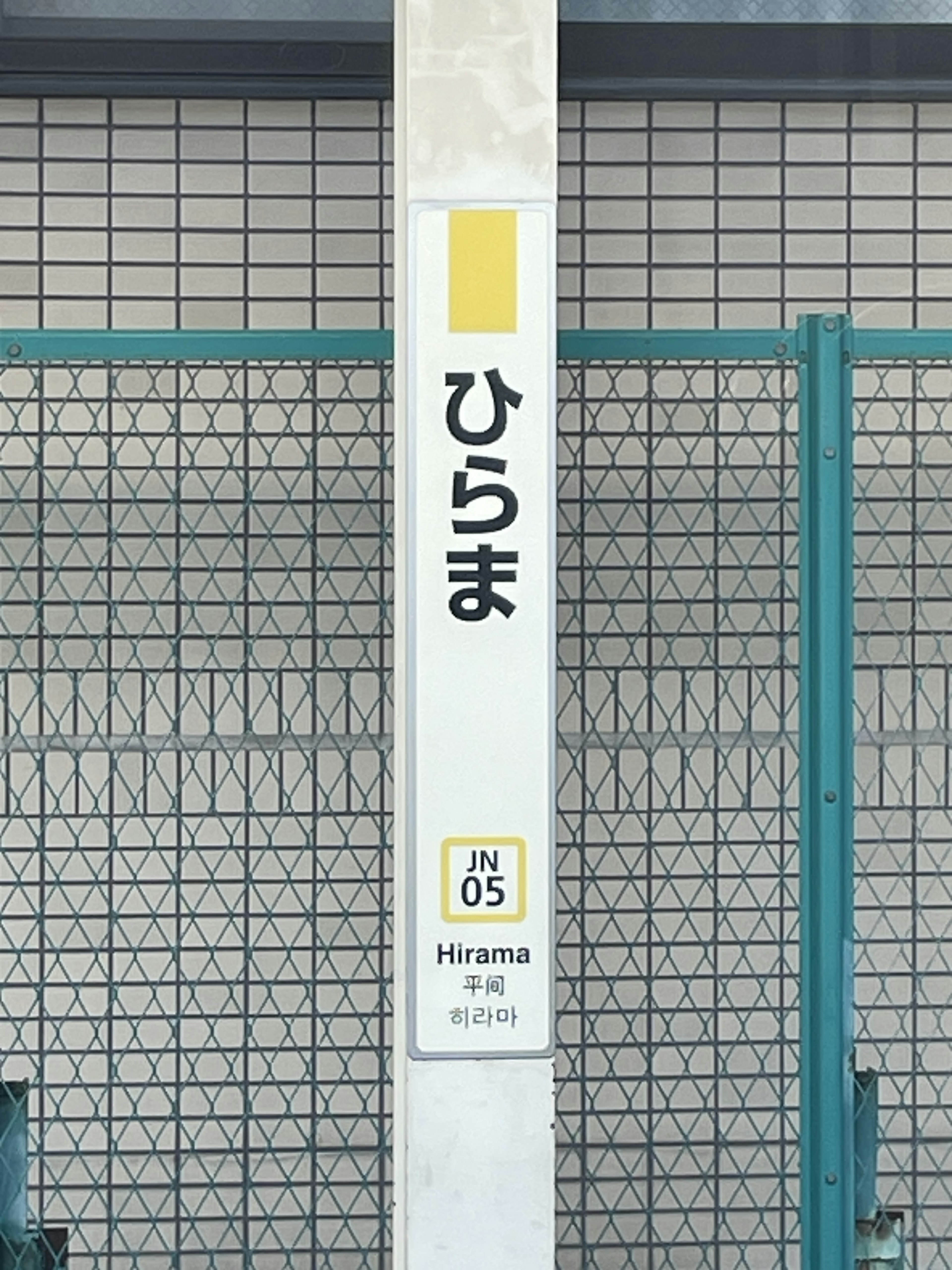 Tanda Stasiun Hirama dengan teks Jepang dan kode stasiun