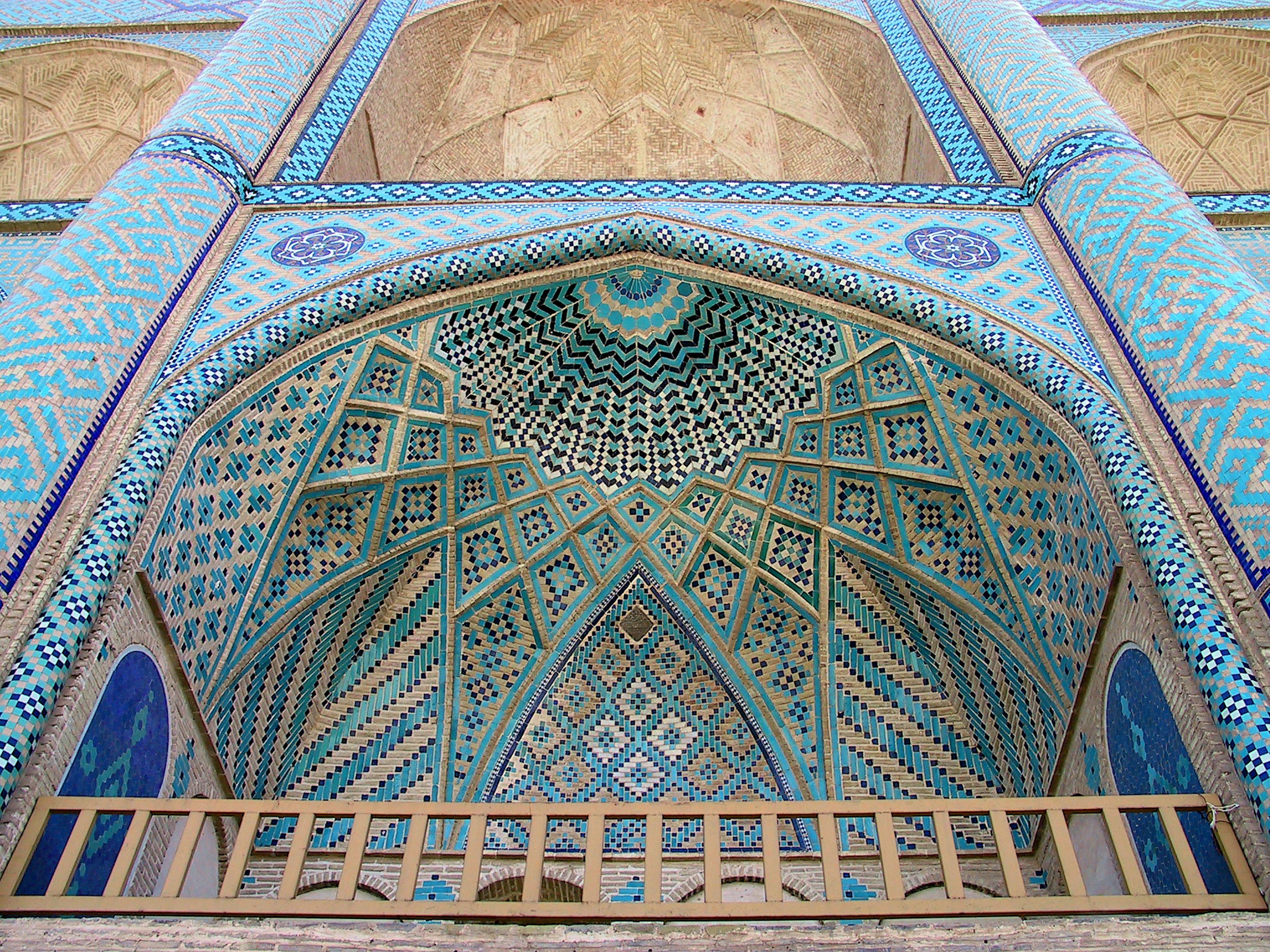 Beautiful blue tile arch and geometric patterned ceiling