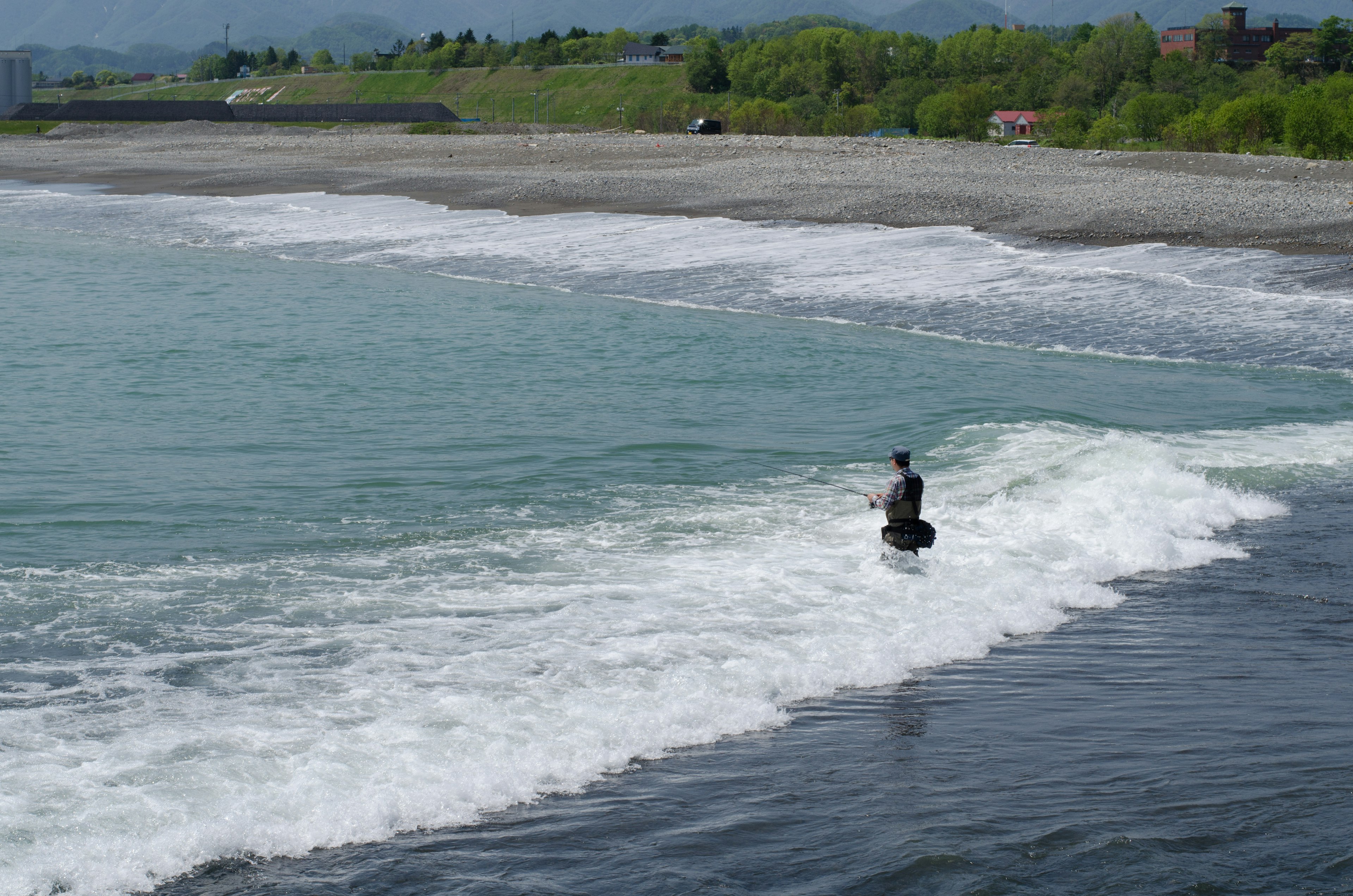 Person surfing on a wave with blue ocean scenery