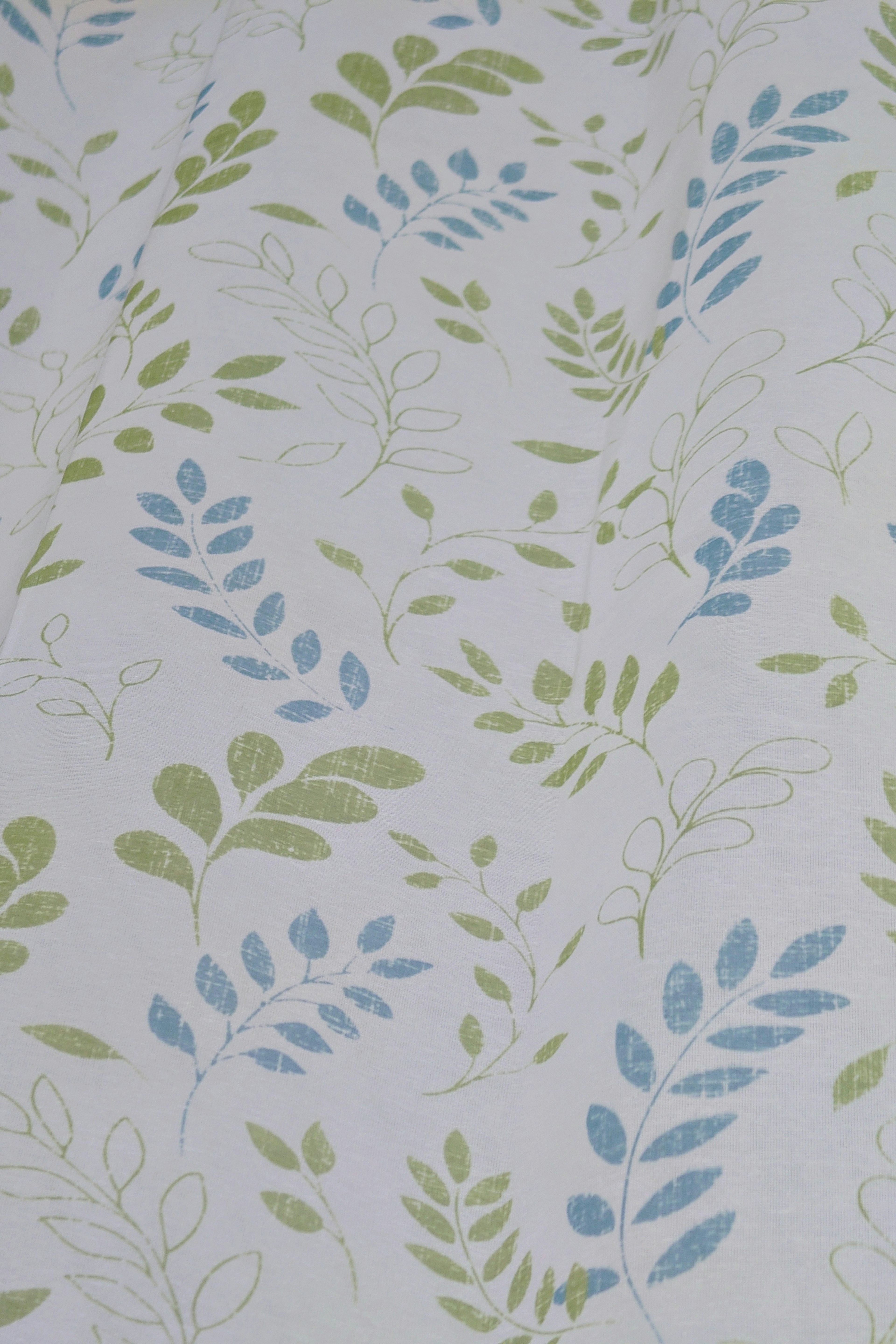 Fabric background with a pattern of light-colored leaves