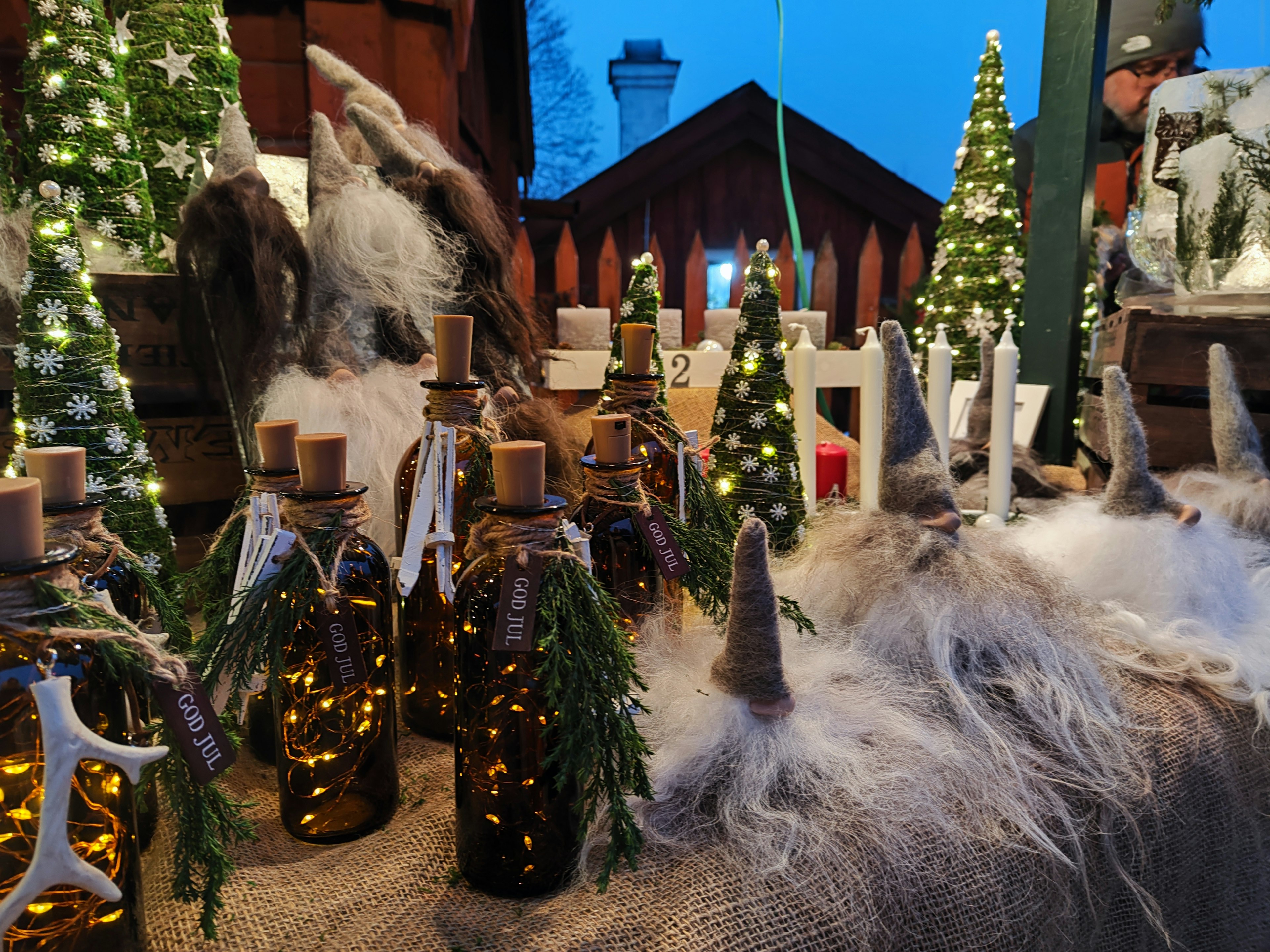 A festive display of decorative bottles and Christmas trees at a market