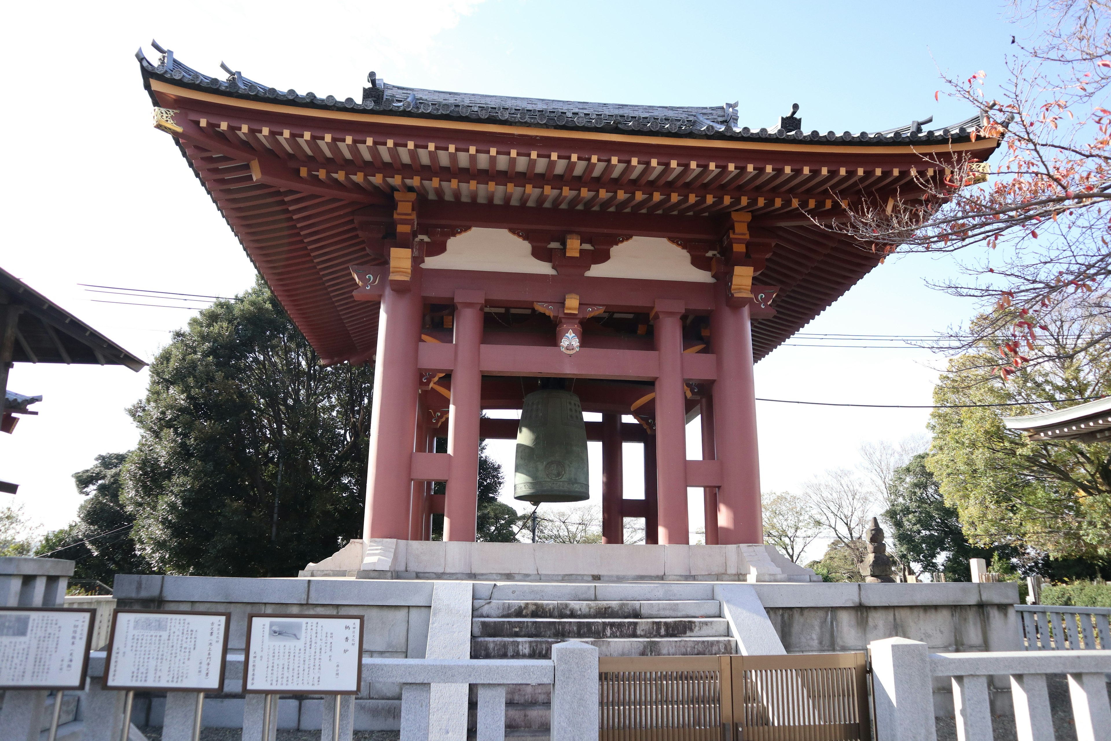 Bell tower structure with detailed architecture in a temple setting