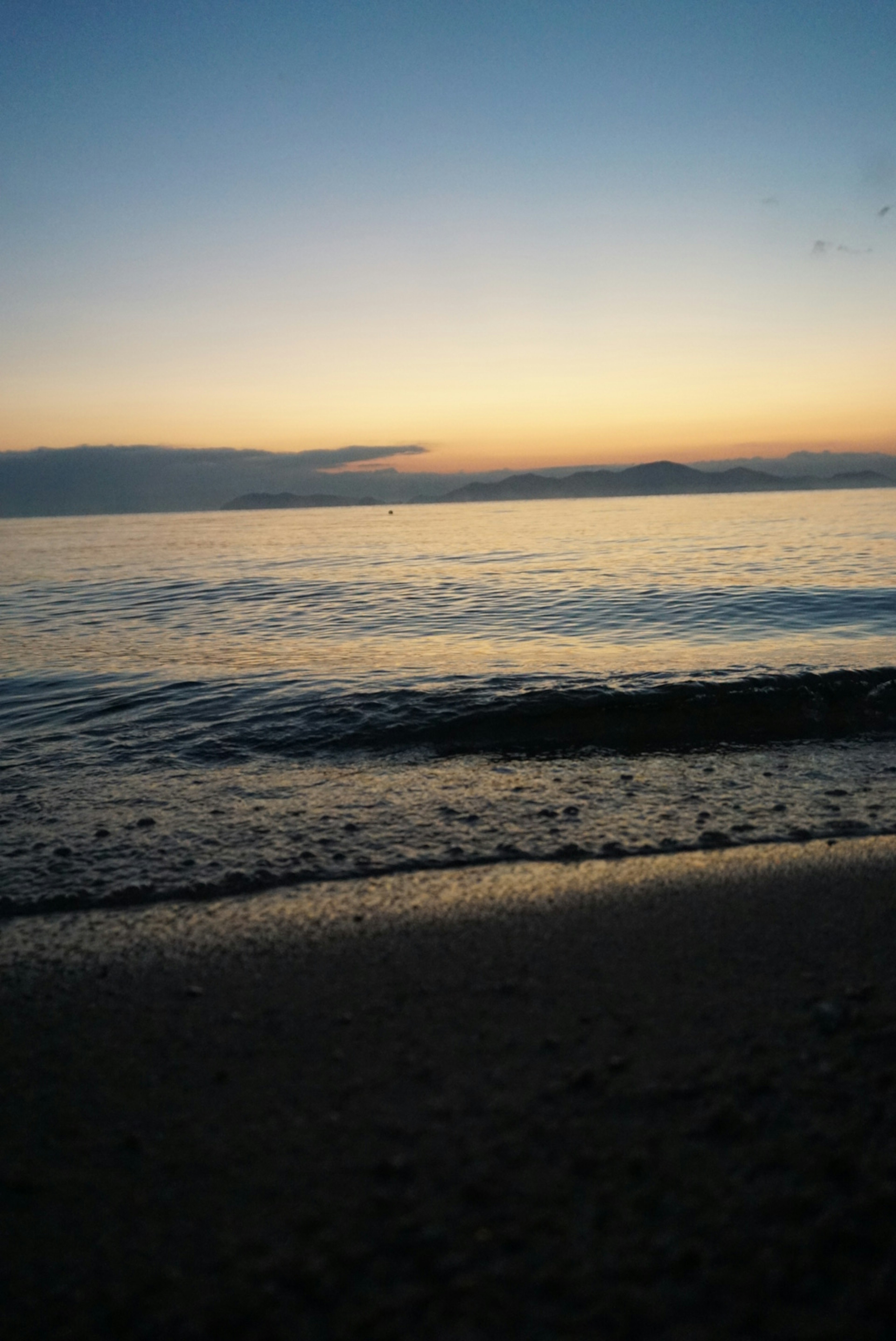 Serene beach at sunset with gentle waves