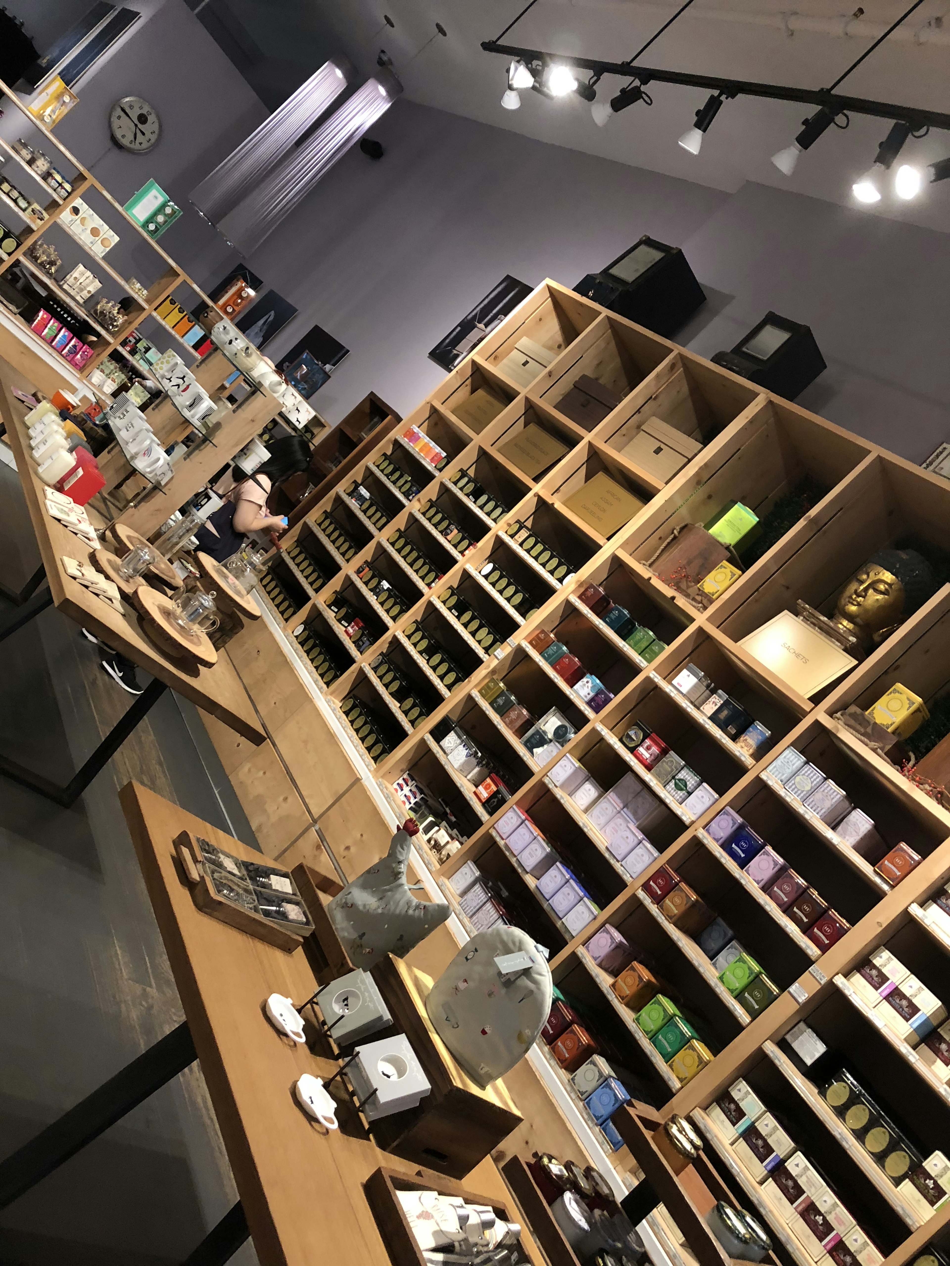 Interior view of a shop featuring wooden shelves filled with various products