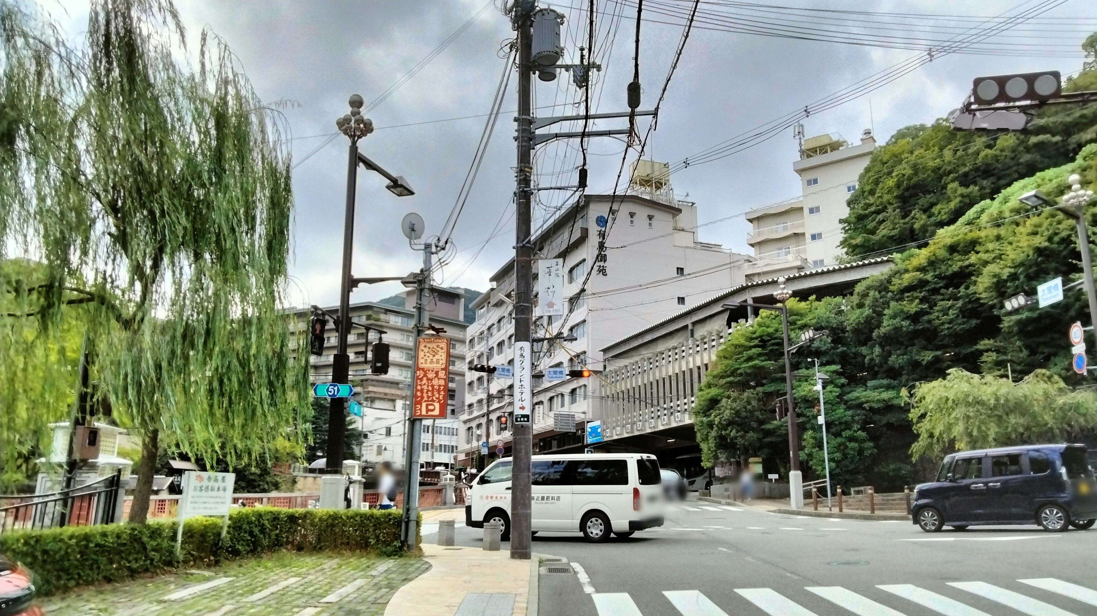 Intersection view with lush greenery and buildings