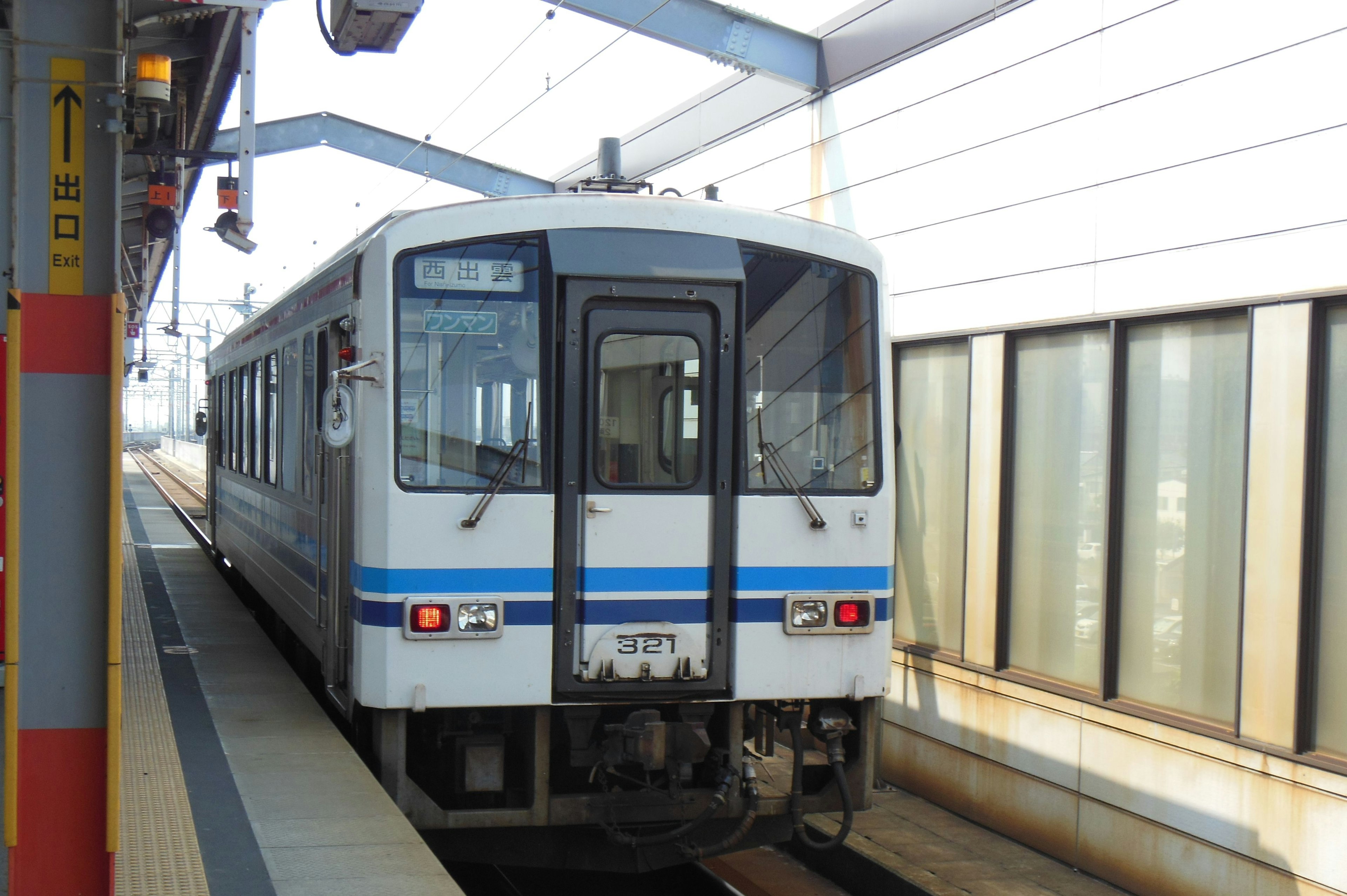 Blue and white train stopped at a station