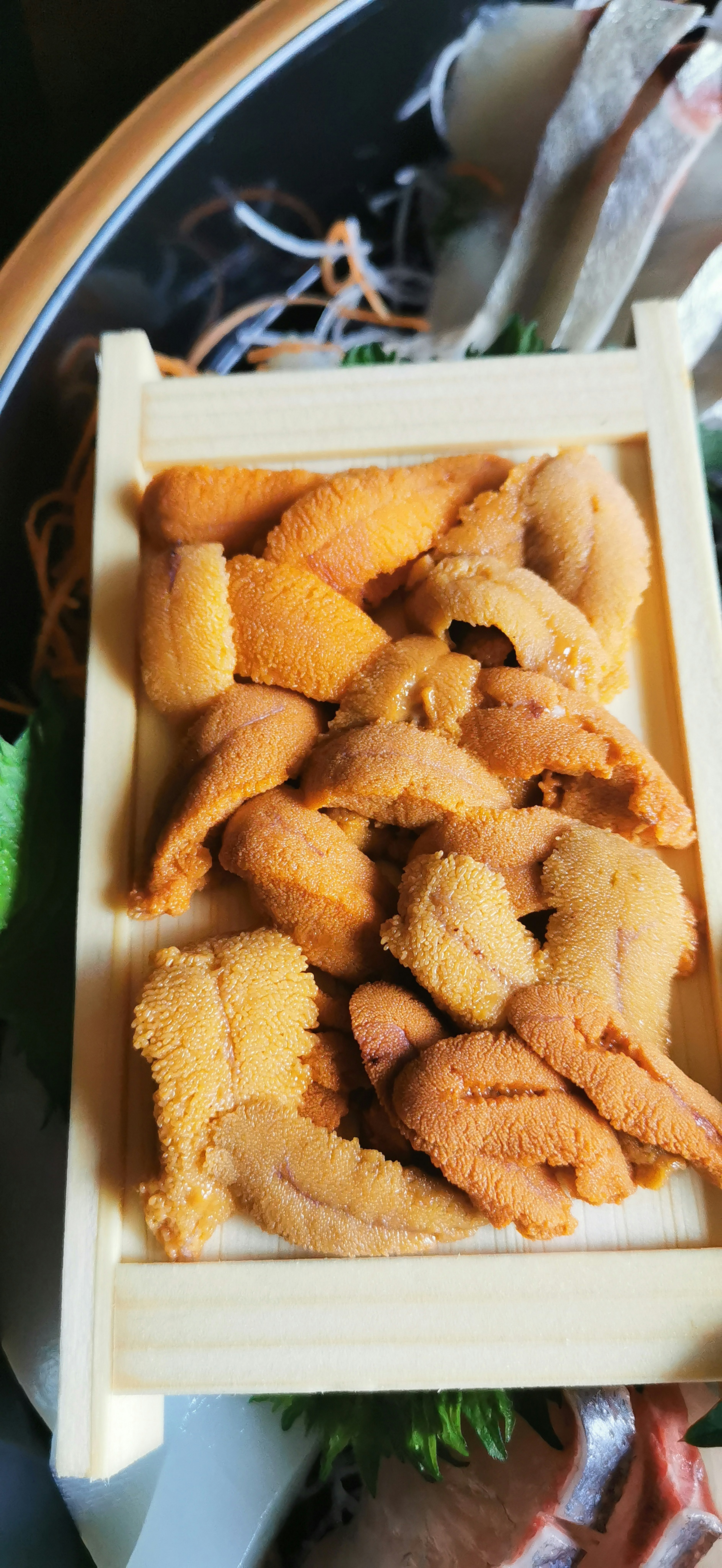 Fresh sea urchin served in a wooden box