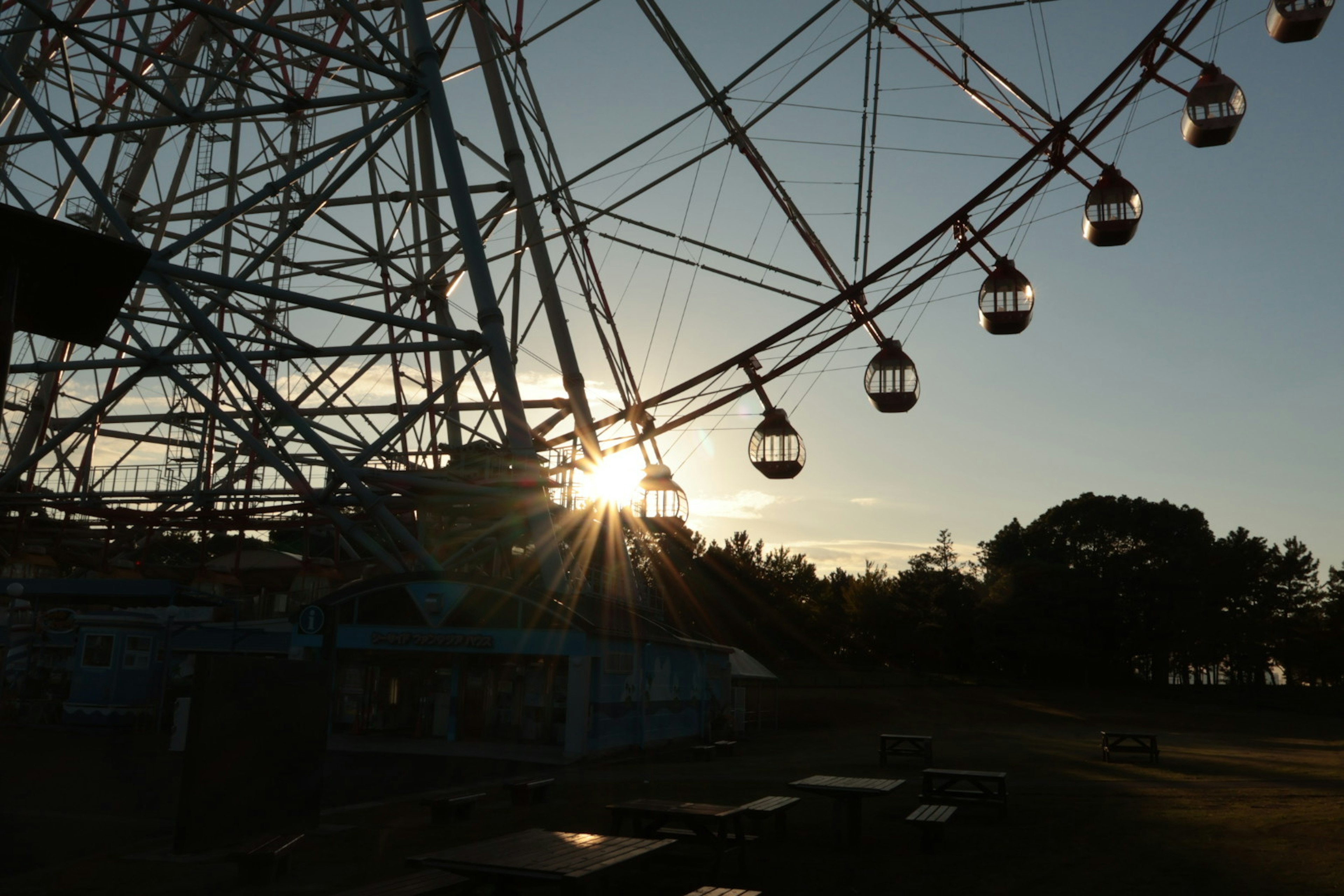 Silhouette of a Ferris wheel against the sunset